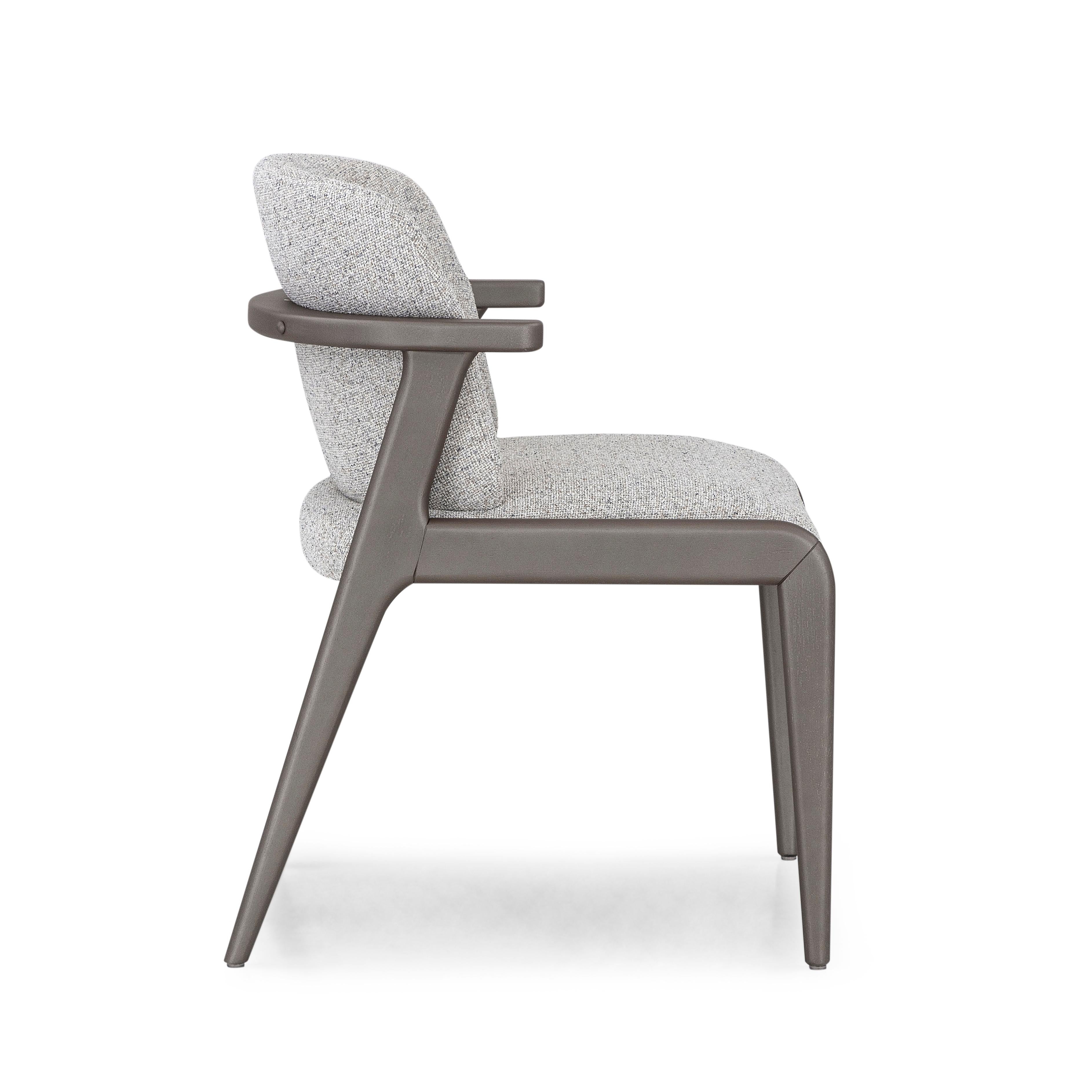 A Nowe dining chair designed by Sérgio Batista for Uultis with Chocolate metallic finish and beige fabric. The Nowe dining chair is an elegant fusion of contemporary design and organic inspiration, drawing from the mystique of Nowe Czarnowo in