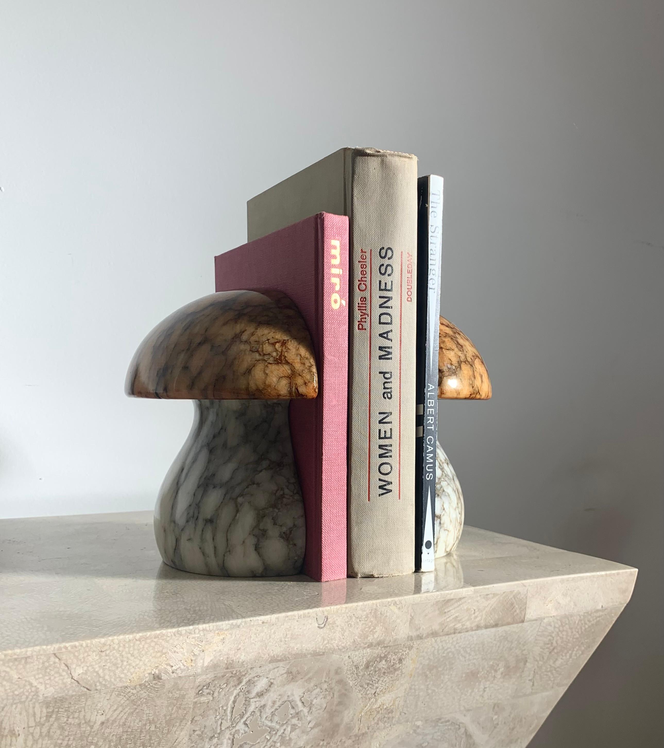A pair of Mid-Century Modern vintage Italian marble alabaster mushroom bookends by Noymer. Hand-carved in Italy, circa early 1960s. Please note the sticker still intact on base of bookend for provenance. The bases are cream with ash veining, whilst