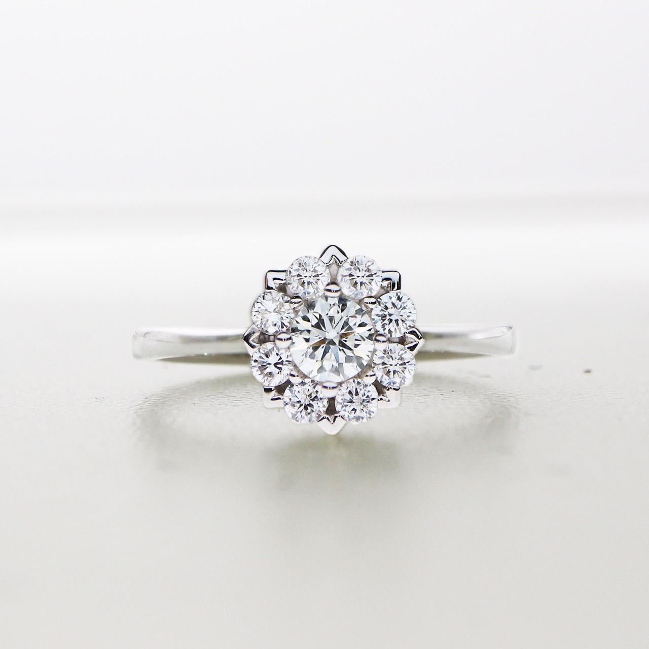 *GIA H VS2 0.23 Ct Flower Shape Diamond Engagement Ring*
GIA-Certified H VS2 diamond as the center stone weighing 0.23 ct set with 8 pieces of FG VS round brilliant diamonds weighing 0.20 ct on the 14K white gold band. 

The classic flower shape