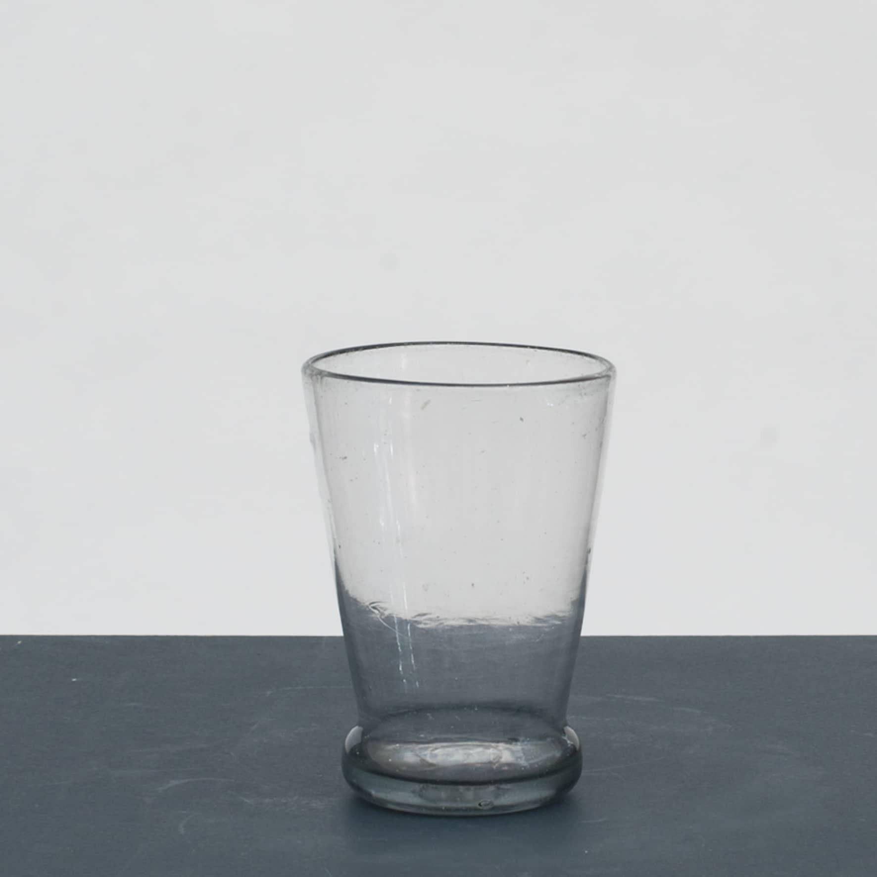 Nøstetangen Dommernix beaker with greyish tint, conical cup with bulge above the slightly arched base - a half-pot glass.
Dommernix is a Norwegian simplification of the German phrase ( tue mir nichts )

From the Norwegian glasswork Nøstetangen
