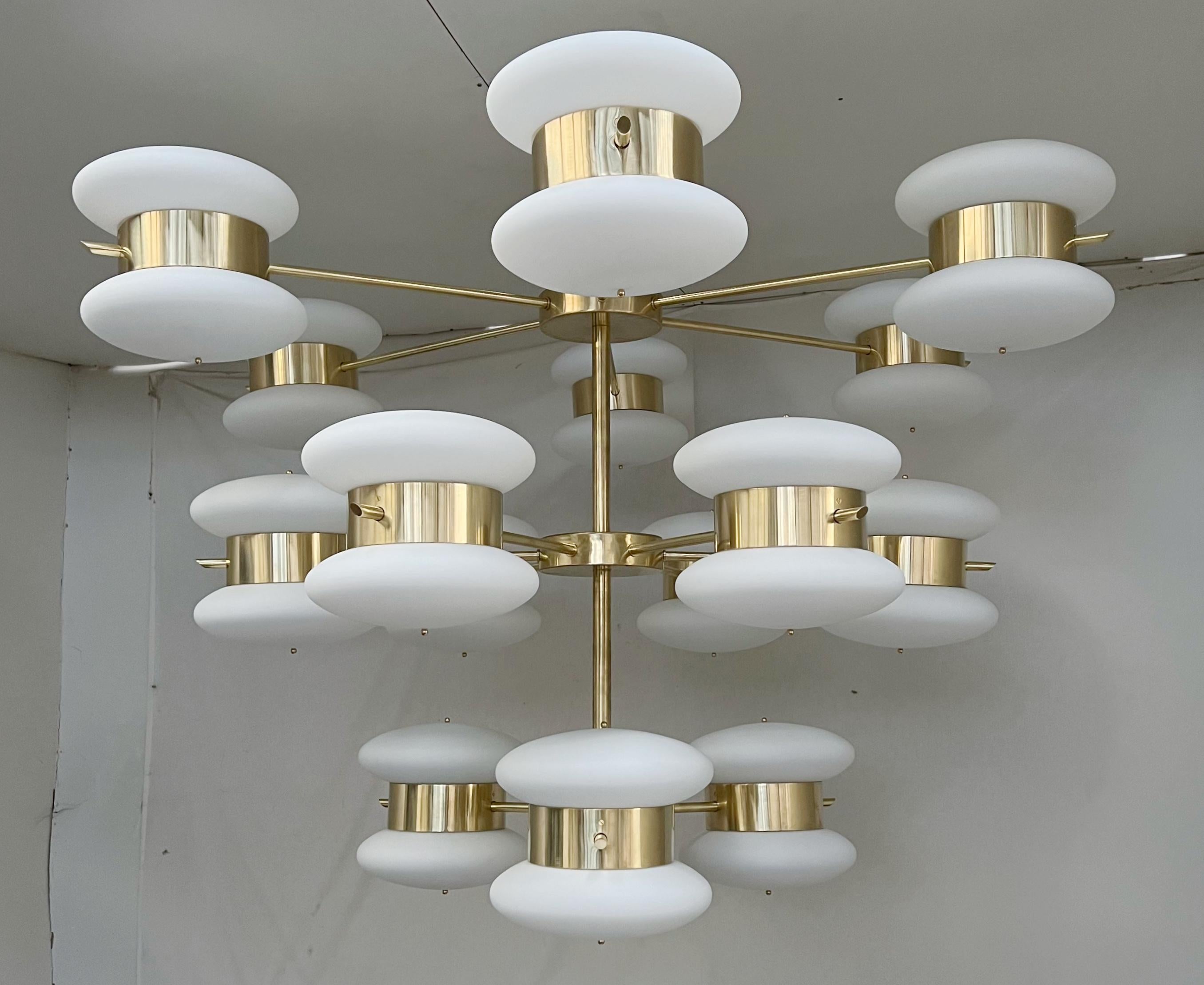 Italian midcentury style chandelier with 3 tiers of opaline matte white Murano glass shades mounted on cascading structure in natural brass finish / Made in Italy
30 lights / E12 or E14 type / max 40W each
Measures: Diameter 63 inches, height 48