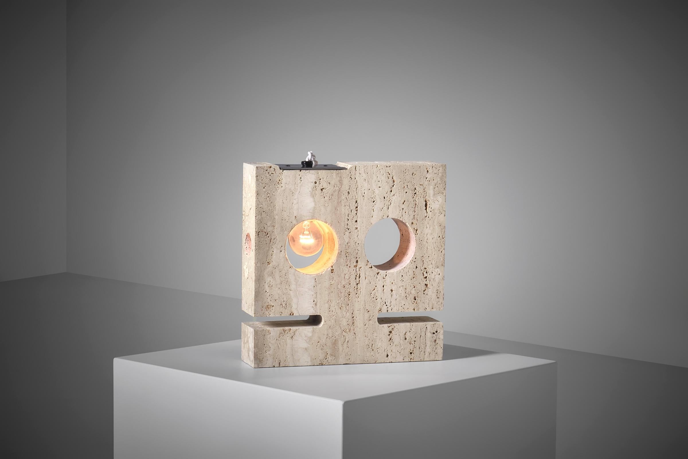 Sculptural Travertine table lamp by Guliano Cesari for Nucleo Sormani, Italy ca. 1970. Sculptural yet playful forms shaped out of beautiful travertine. The asymmetrical placed cylinder shaped cut out creates a harmonious contrast with the strong