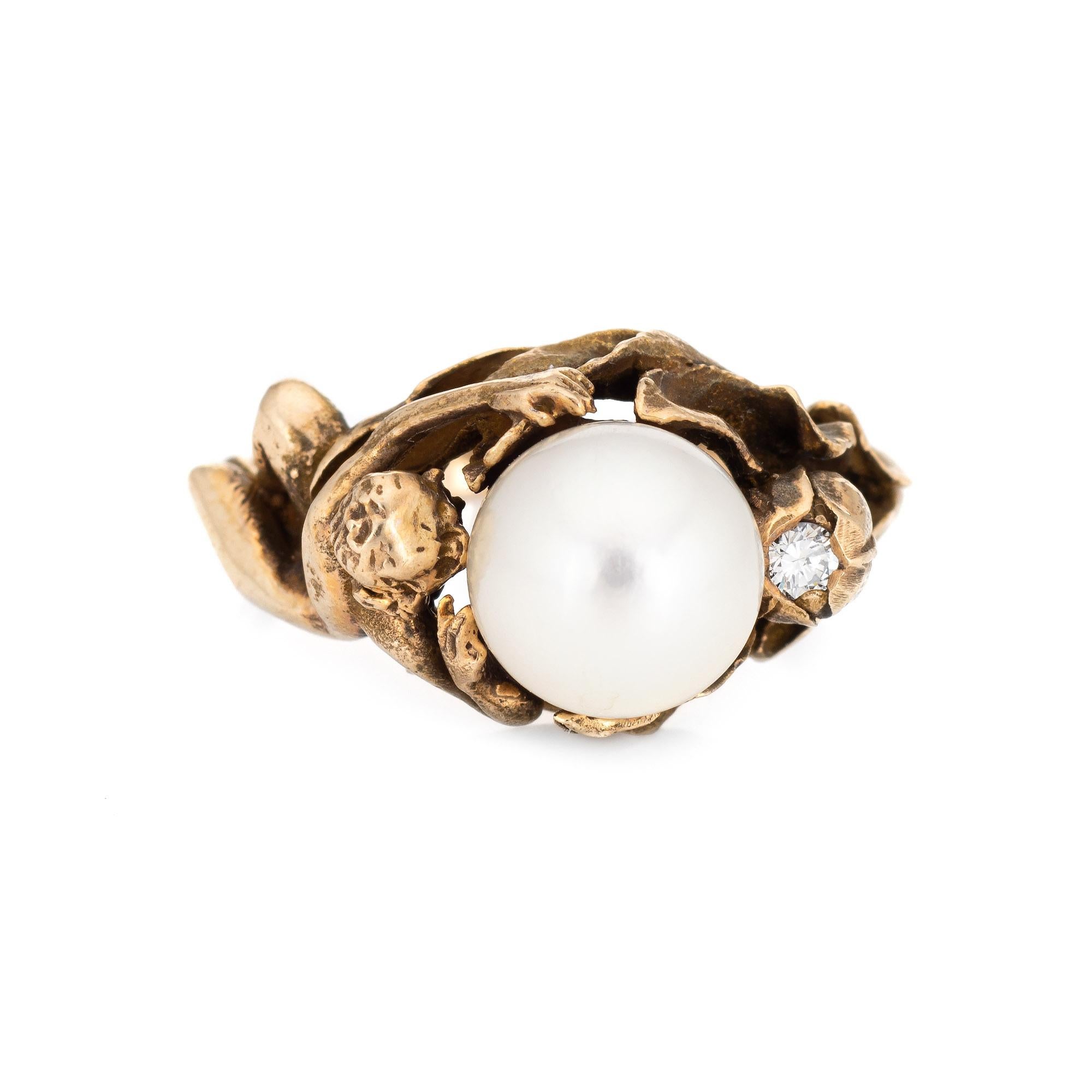 Stylish vintage cultured pearl & diamond nude figural ring crafted in 14 karat yellow gold (circa 1960s). 

Cultured pearl measures 8mm, accented with an estimated 0.04 round brilliant cut diamond (estimated at H-I color and SI1 clarity).

The