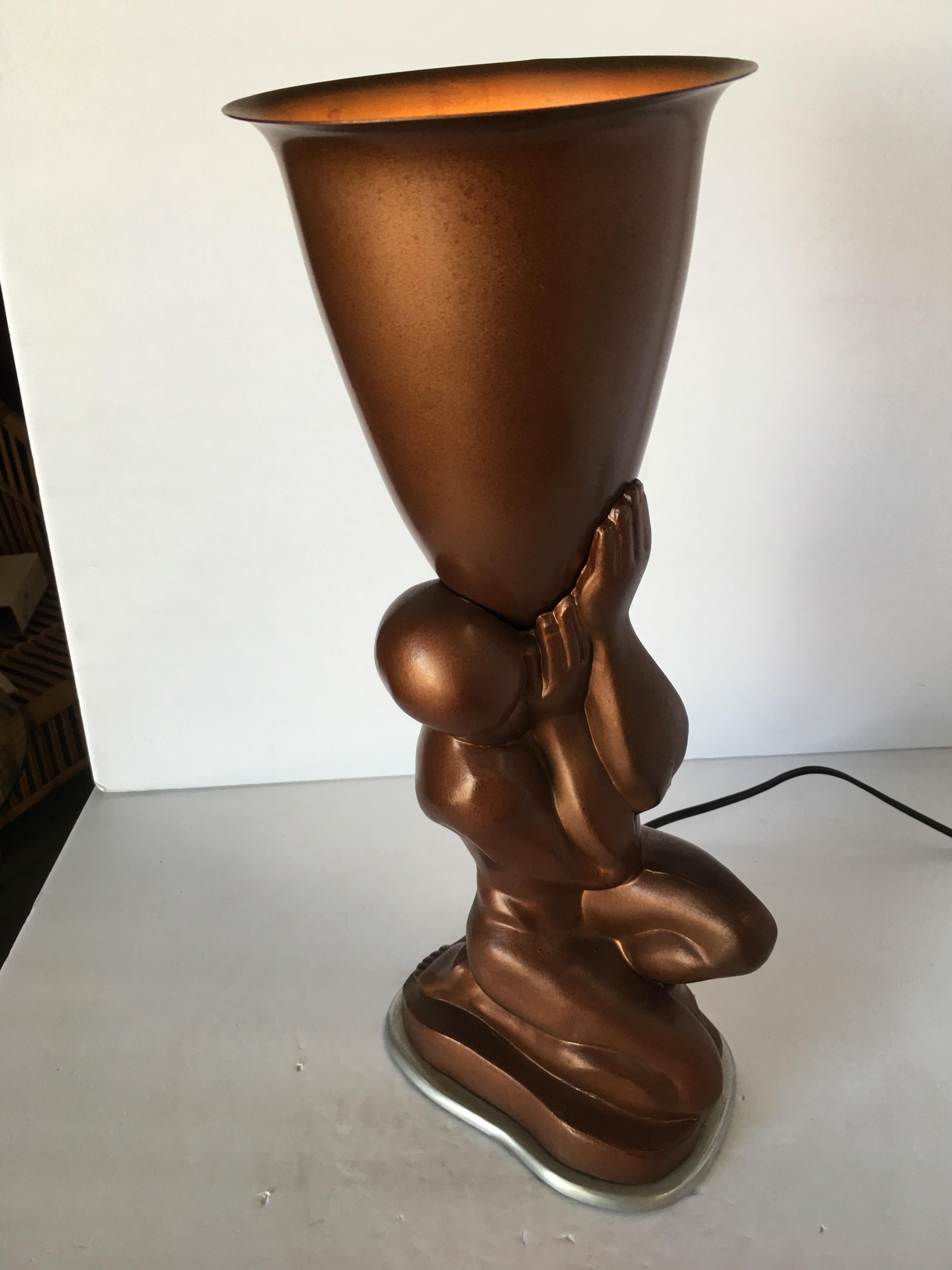 Nude Bronze modern male torchiere Lamp featuring a modernist nude male holding up a torchiere shade.