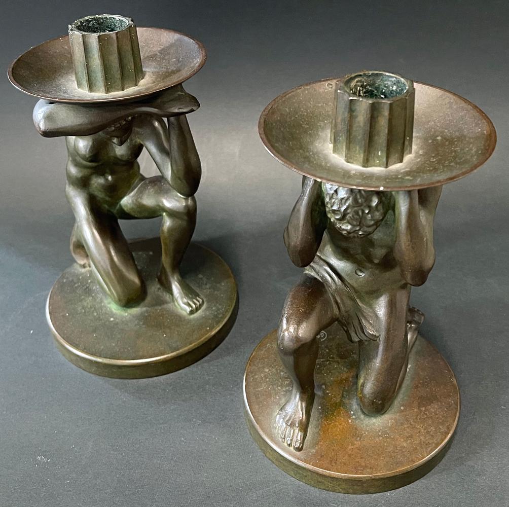 This stunning pair of Art Deco bronze candlesticks, influenced by Classical sculptural paradigms but very much executed in a modern, Art Deco manner, was created by Carl Sorensen, a craftsman working in Philadelphia in the Art Nouveau and Art Deco