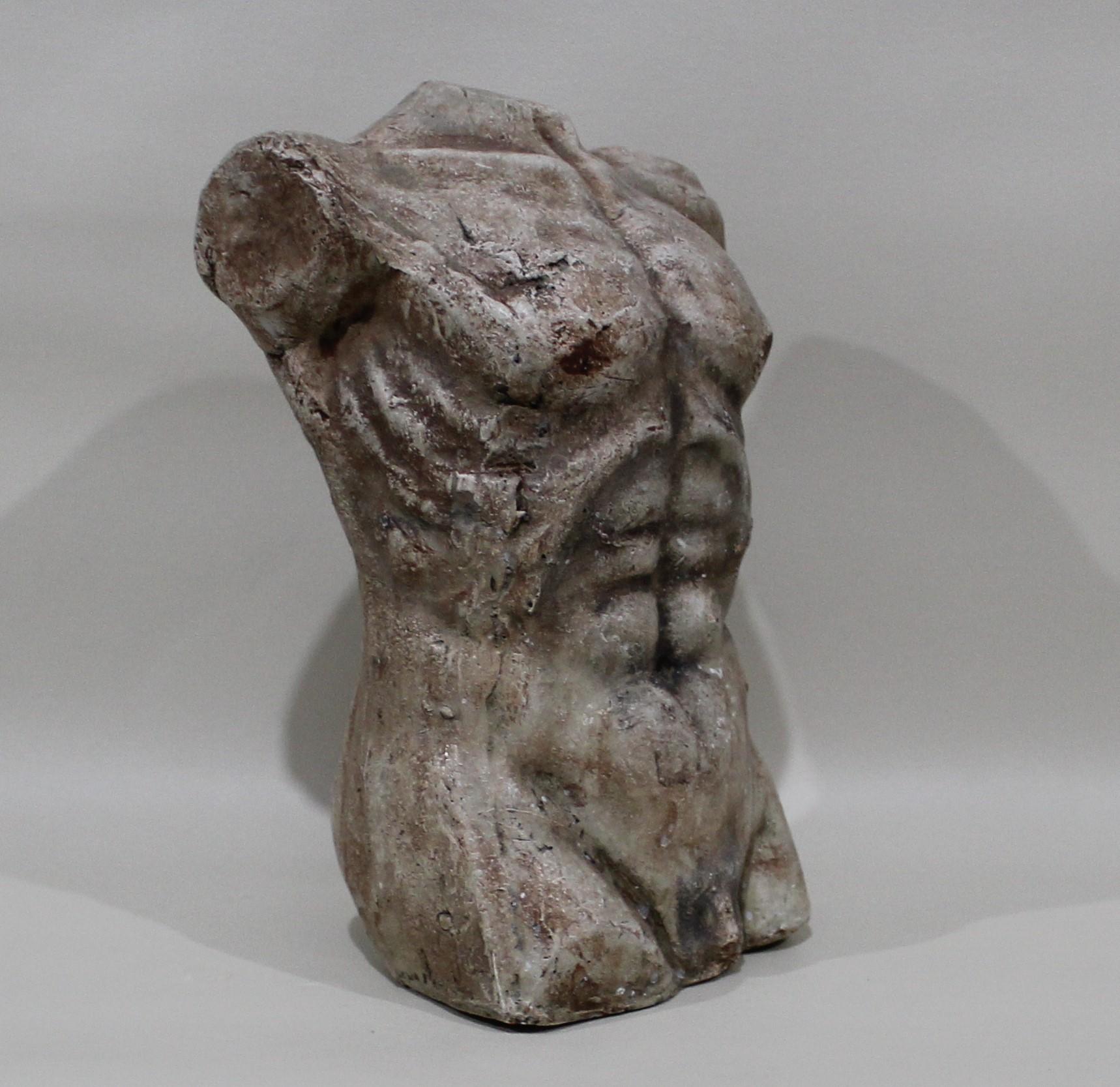 Nude male torso sculpture made of plaster.