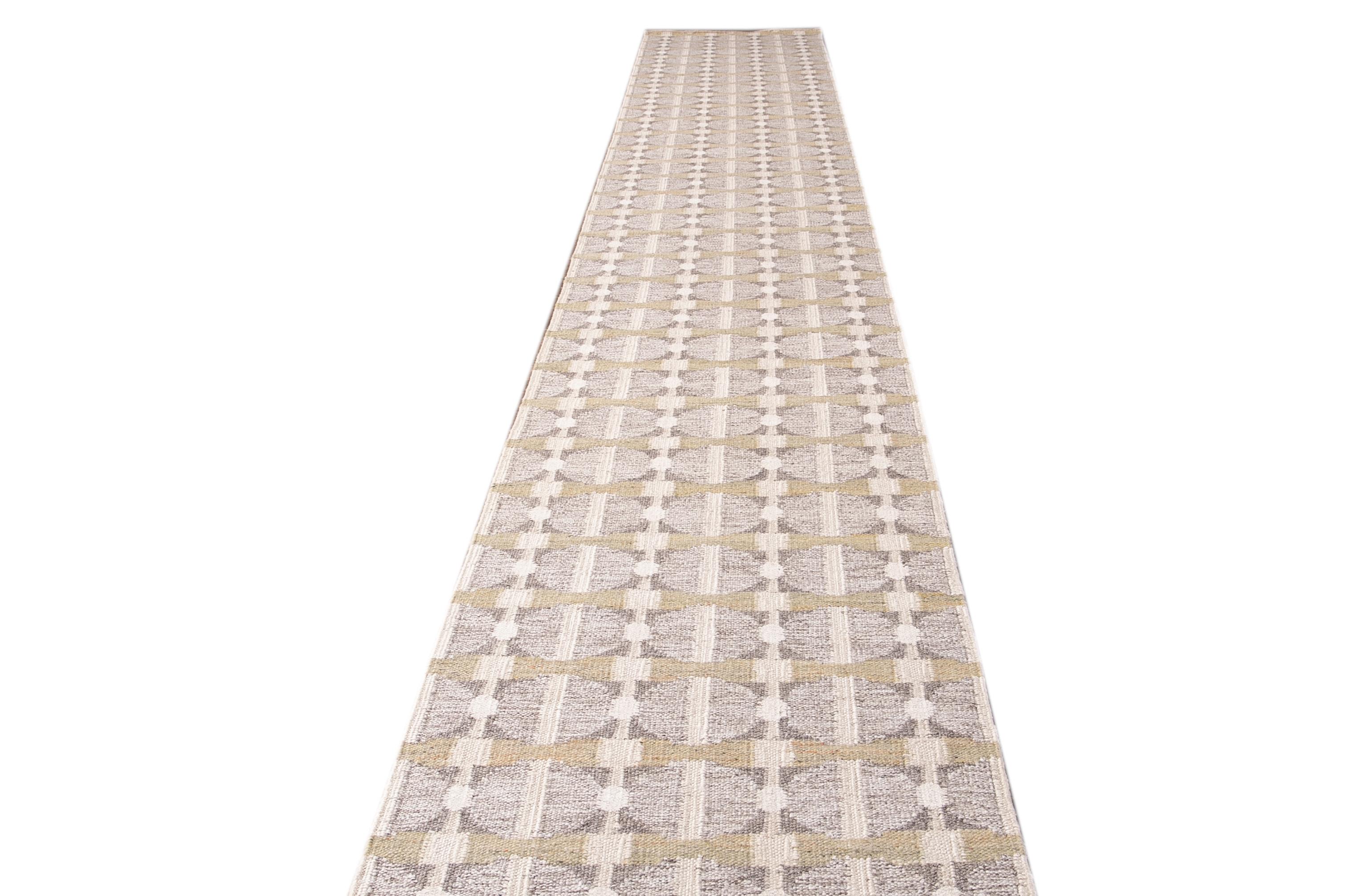 Beautiful modern long Swedish hand-knotted wool runner with a beige field. This Swedish runner has accents of gray and yellow in an all-over geometric abstract design.

This rug measures 2'11