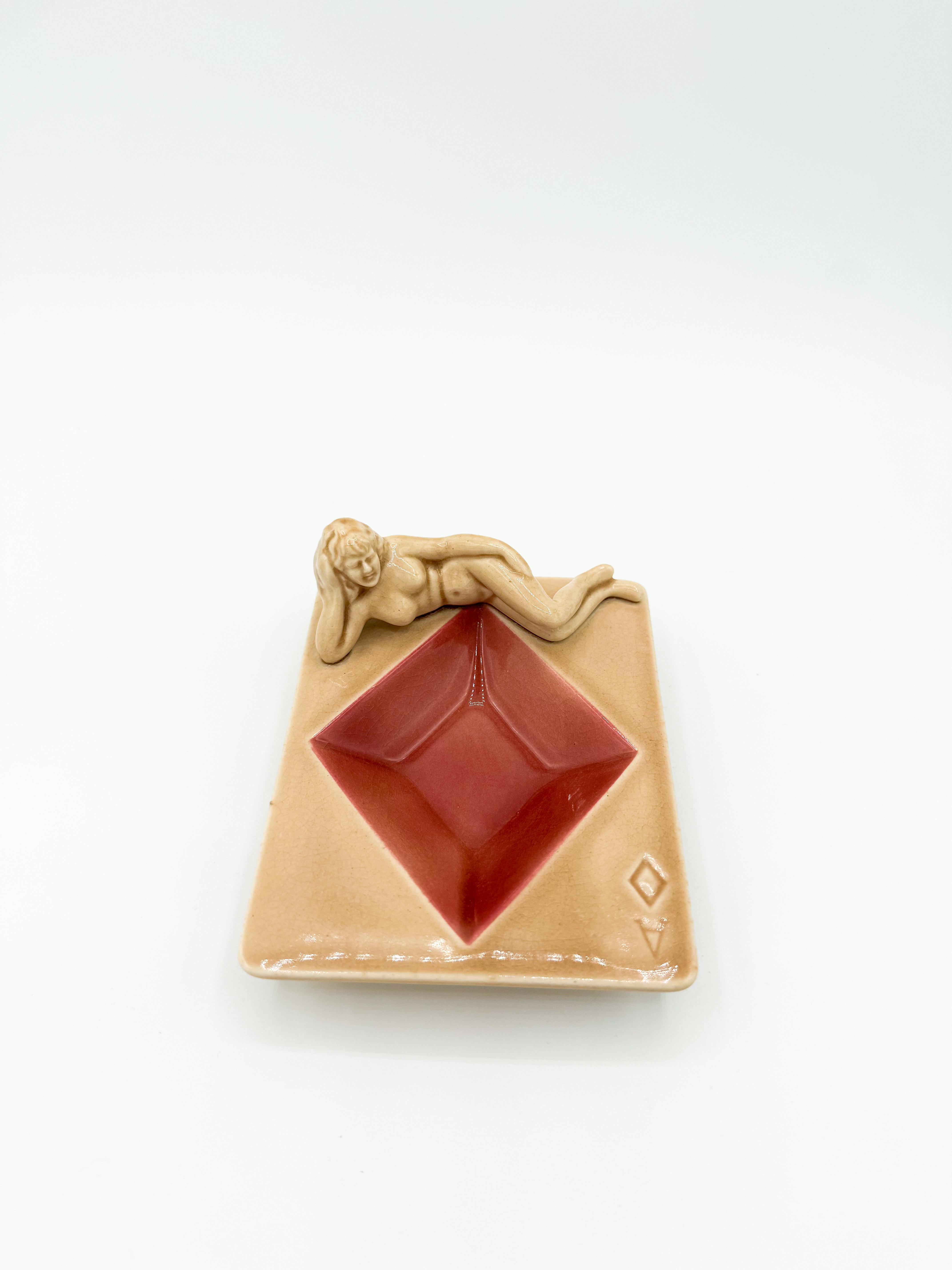 Vintage Diamond Nude Ashtray made by Stafford in Japan during the 1940s. Featuring a charming pinup girl lounging gracefully, this porcelain piece captures the playful elegance of the era. Each ashtray is marked 
