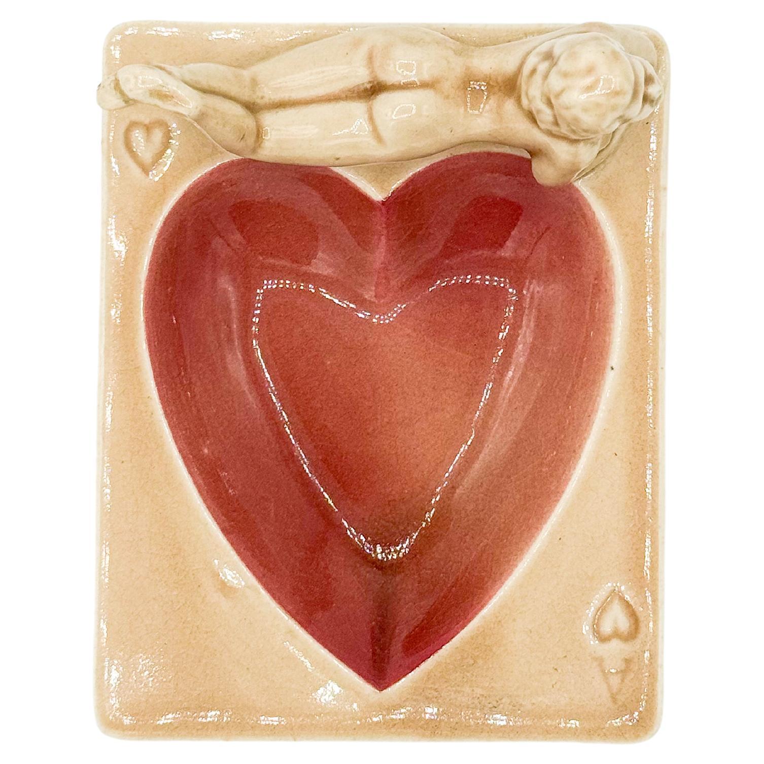 Vintage Heart Nude Ashtray made by Stafford in Japan during the 1940s. Featuring a charming pinup girl lounging gracefully, this porcelain piece captures the playful elegance of the era. Each ashtray is marked 