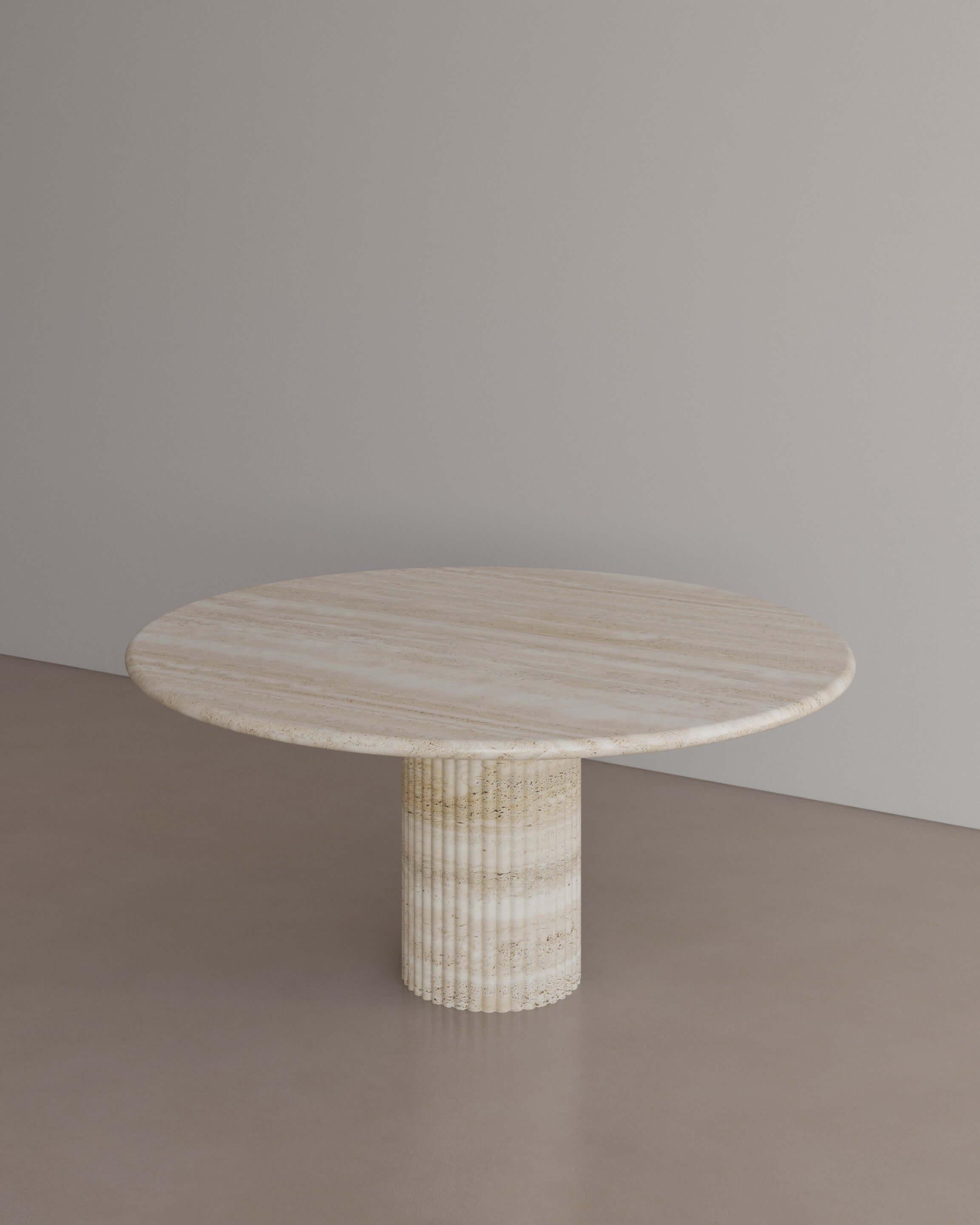 The Essentialist brings you The Antica Dining Table I in Nude Travertine. An oval table top resolved by smooth bullnose edges rests on two supporting pillars. Architectural form is refined by artistic expression echoing Roman culture. This table,