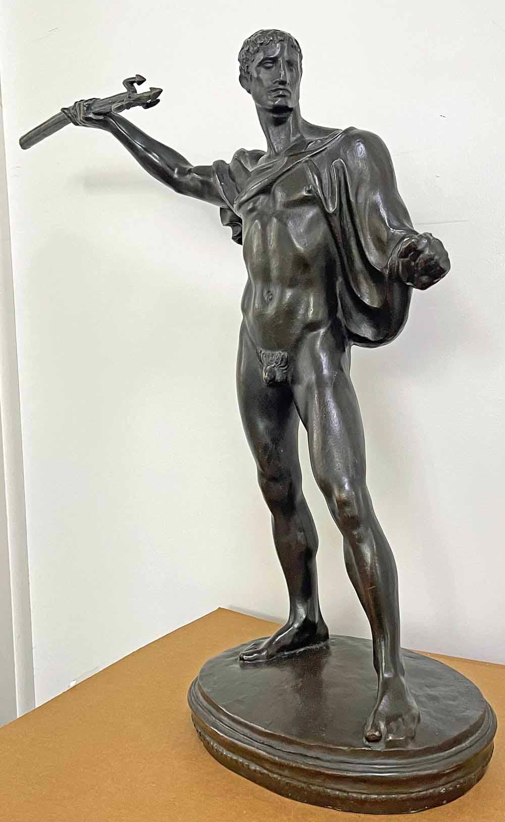 At once strong and sensuous, this large bronze of a fully nude triton figure, his right arm raised high with his trident, ready to strike, was sculpted in the 1920s by Hubert Netzer.  This figure -- a creature of the sea and a companion to Neptune