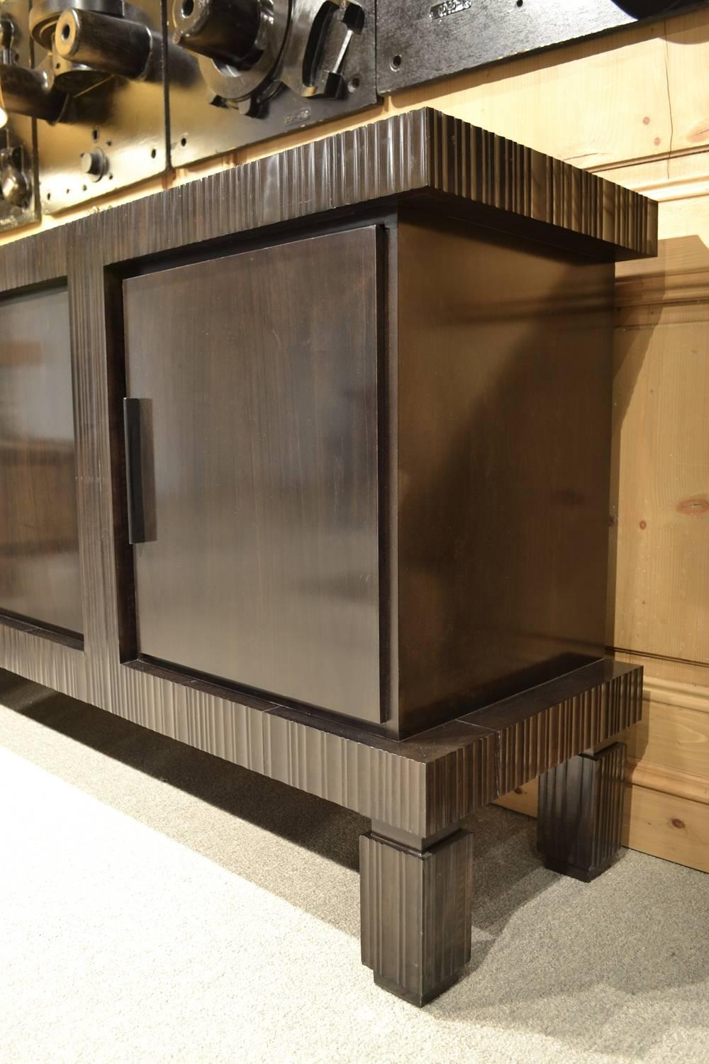 The Nue buffet is an original design by Joann Westwater. It's constructed of maple and maple veneer, lightly distressed and finished is a soft sheen espresso finish. The doors are mounted on full swing Euro hinges and each of the two cabinet areas