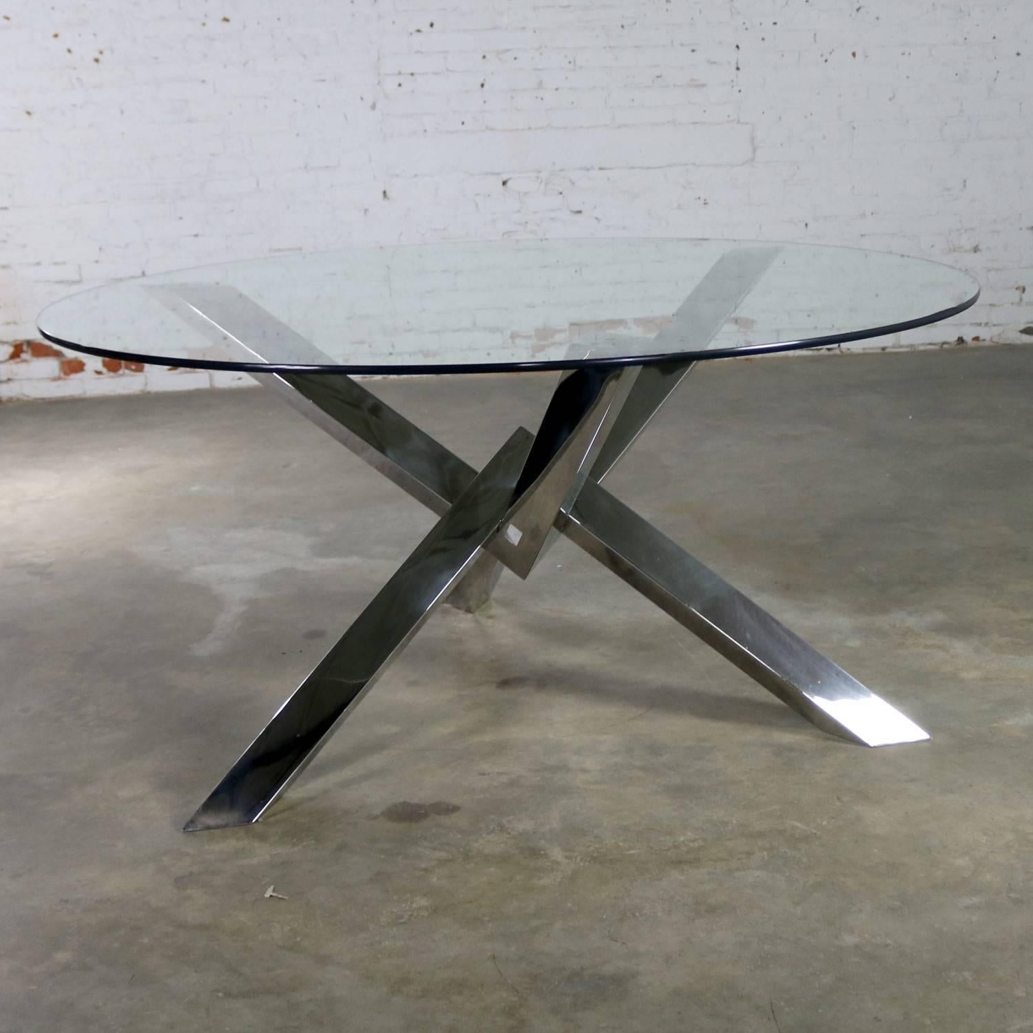 Awesome round glass top dining table with stainless steel jacks style base. This COSTA series table by Nuevo is in current production. This one is recently vintage. It was purchased but never used. It is in wonderful condition, circa 2017.

This