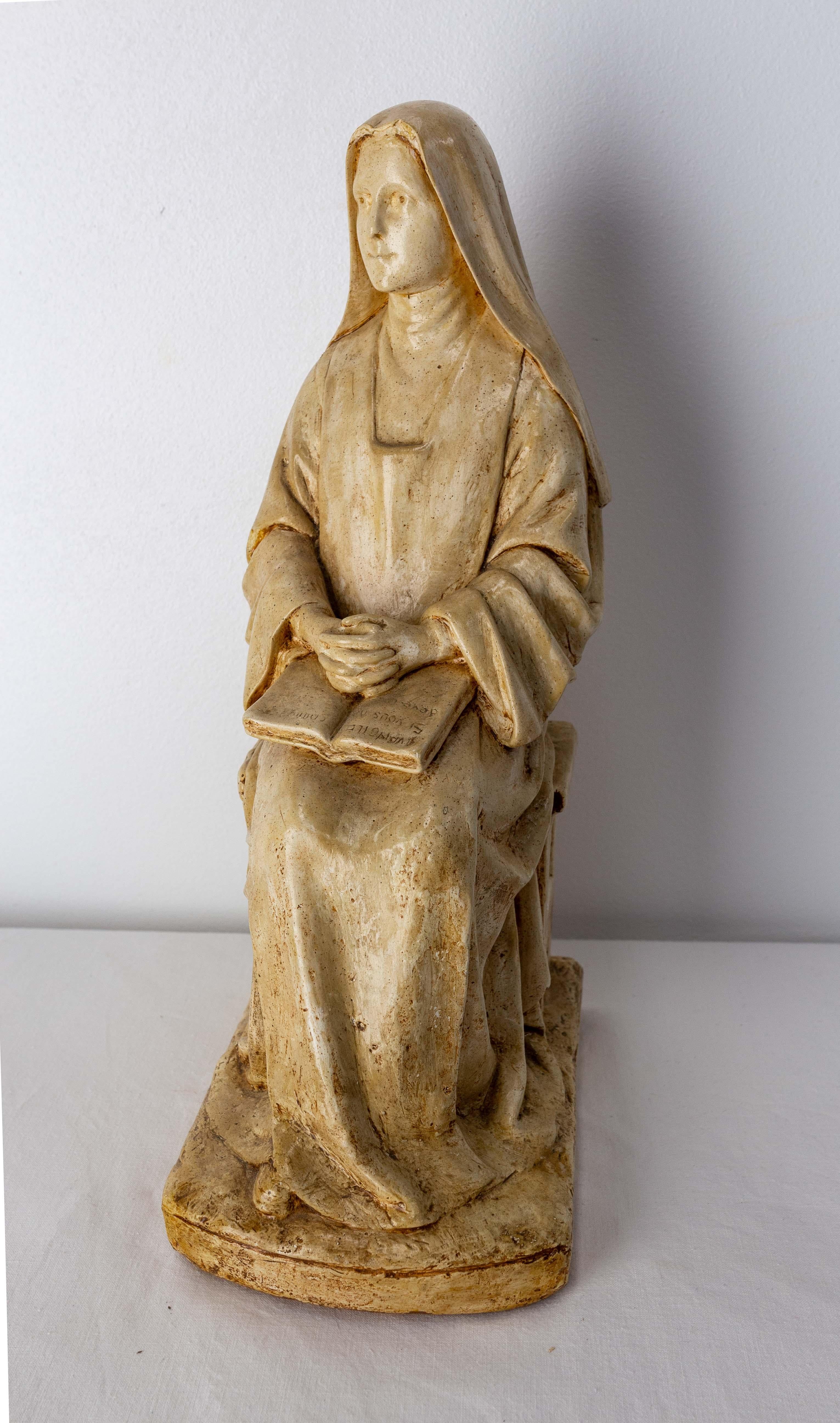 Patinated plaster french statue of a religious reading the Bible.
Antique French, circa 1880s
This nun character inspires serenity.
Created in 1855, the Giscard Manufacture in Toulouse has marked the architecture of its city, both in religious