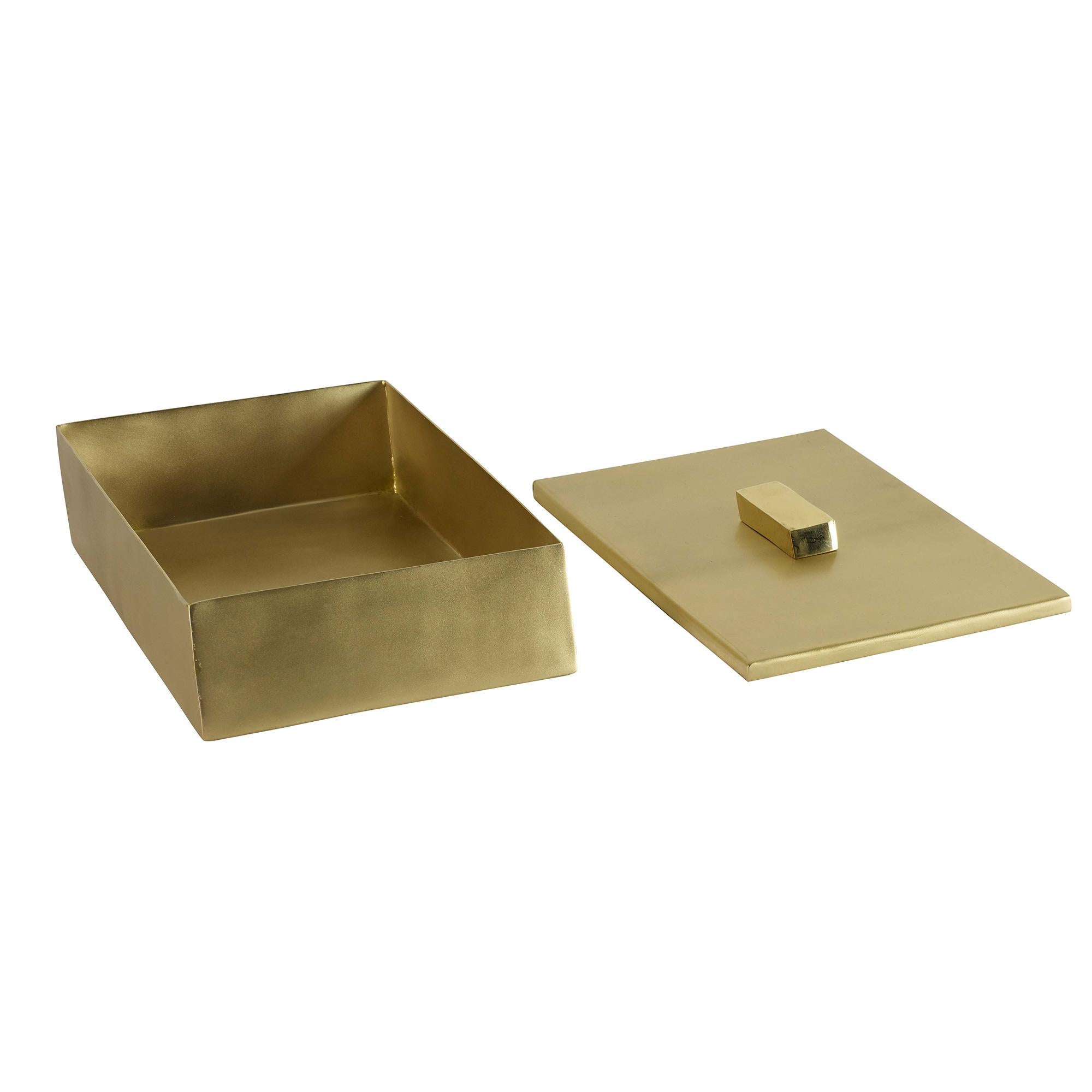A handmade angled brass box featuring a matte finish and a contrasting shiny nob.
 
