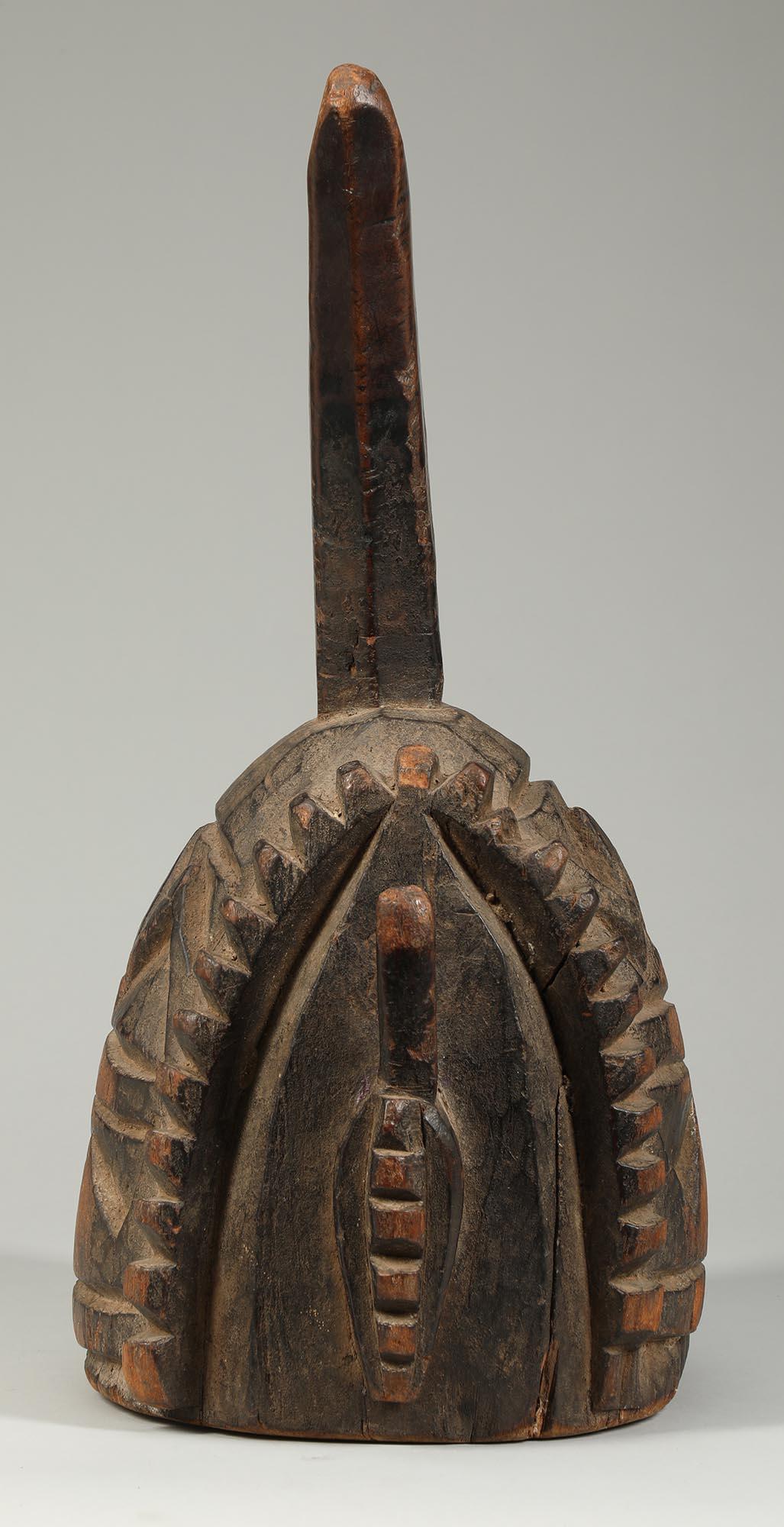 Nupe Helmet shaped carved wood shrine floor polisher West Africa. Used to clear and prepare the dirt surface inside a shrine. Solid carved wood with rising crest that could be used as a handle.  Deep patina from handling and use, heavy smooth wear
