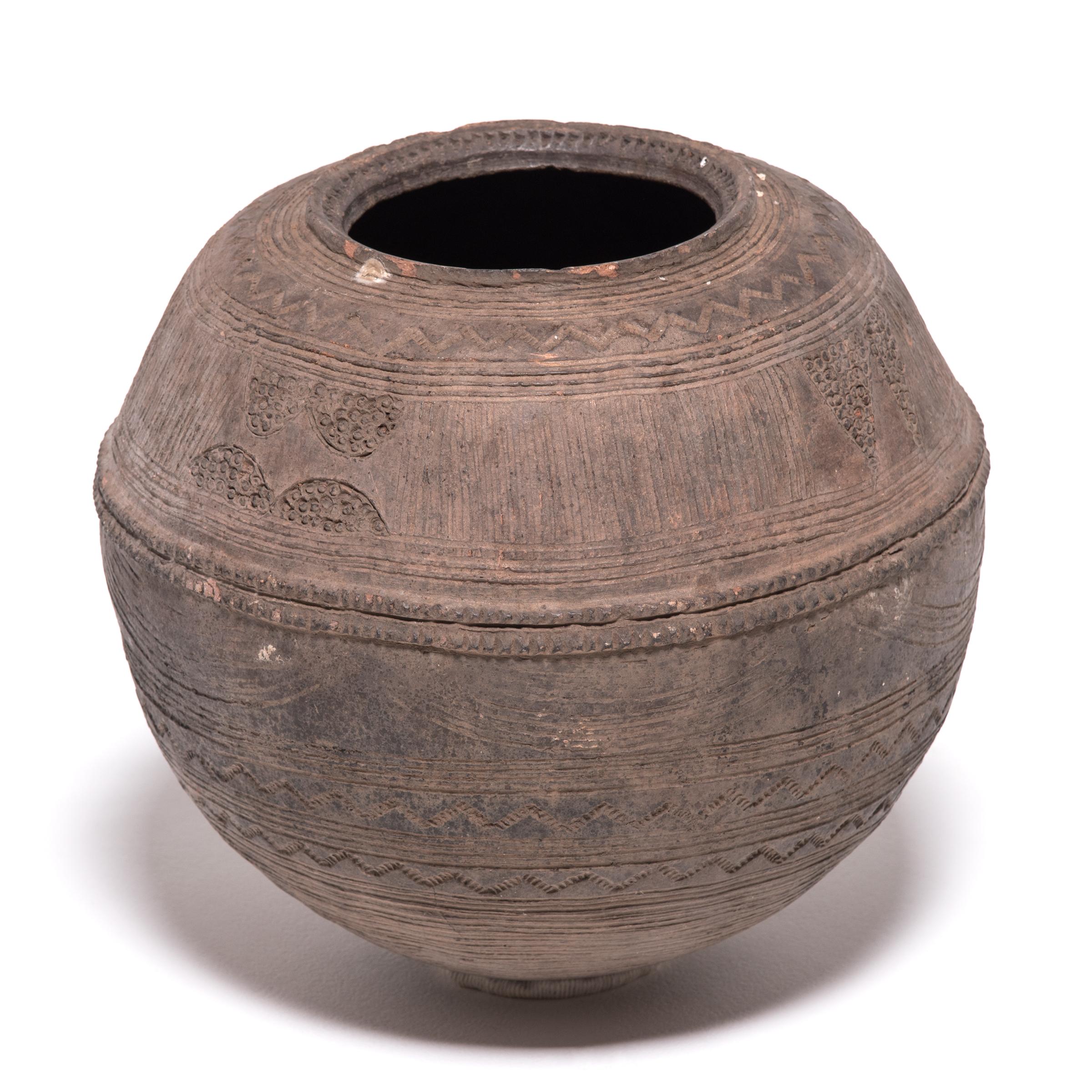 The Nupe people of Nigeria were touted as some of the finest ceramicists in Africa. Everyday objects, like this water vessel, received detailed attention. The vessel's varied textures come from its utilitarian design. The patterns and bands were