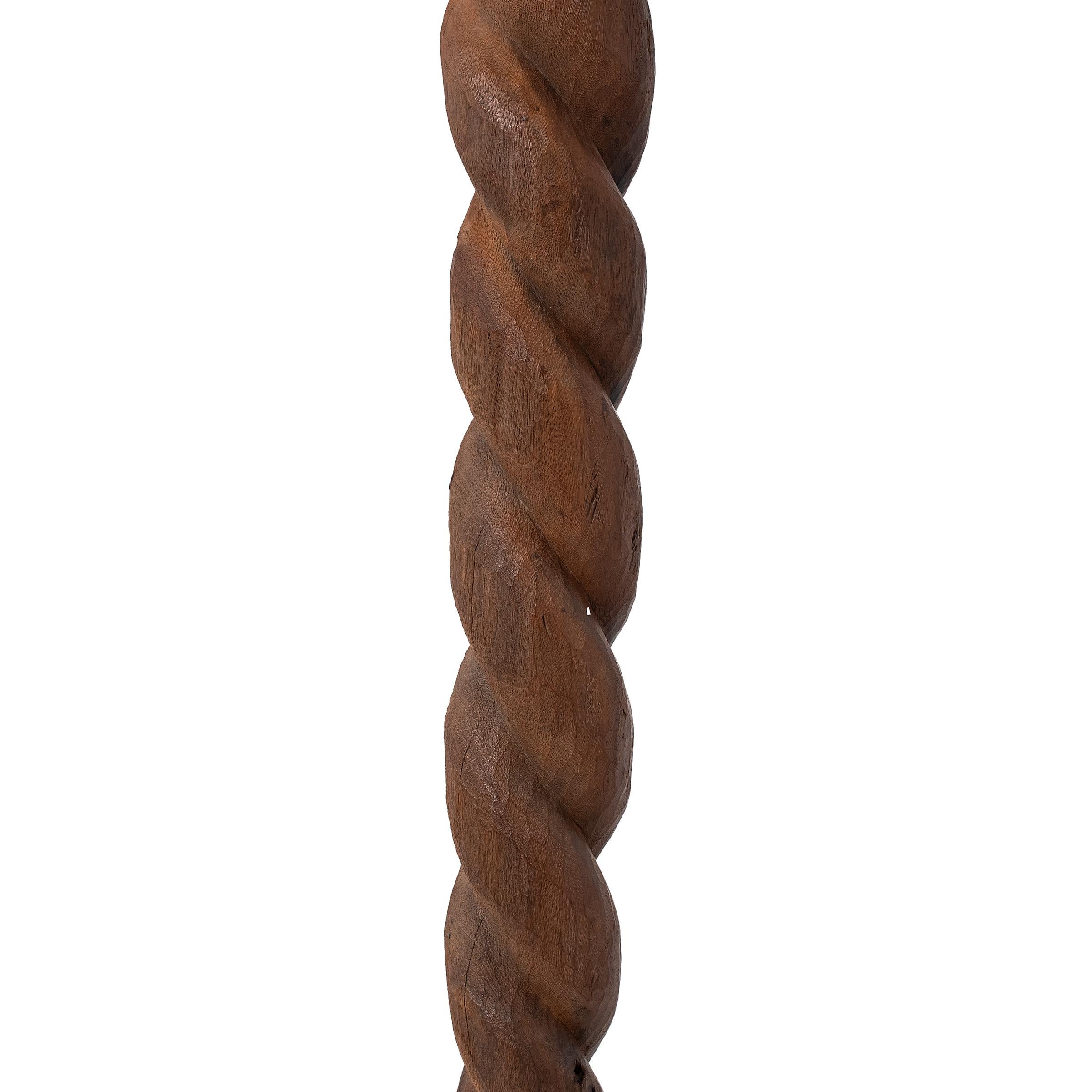 Hand-carved with an abstract design, this tall wooden post is an architectural support beam attributed to the Nupe people of central Nigeria. Like much of Nupe art, support posts are typically carved with simple geometric forms, rather than