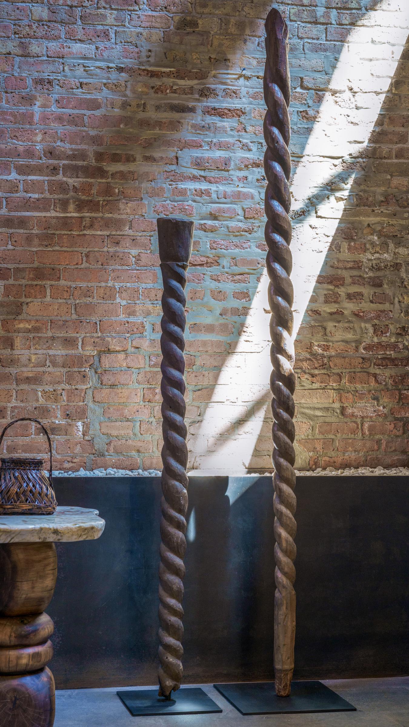 Hand-carved with an abstract design, this tall wooden post is an architectural support beam attributed to the Nupe people of central Nigeria. Like much of Nupe art, support posts are typically carved with simple geometric forms, rather than