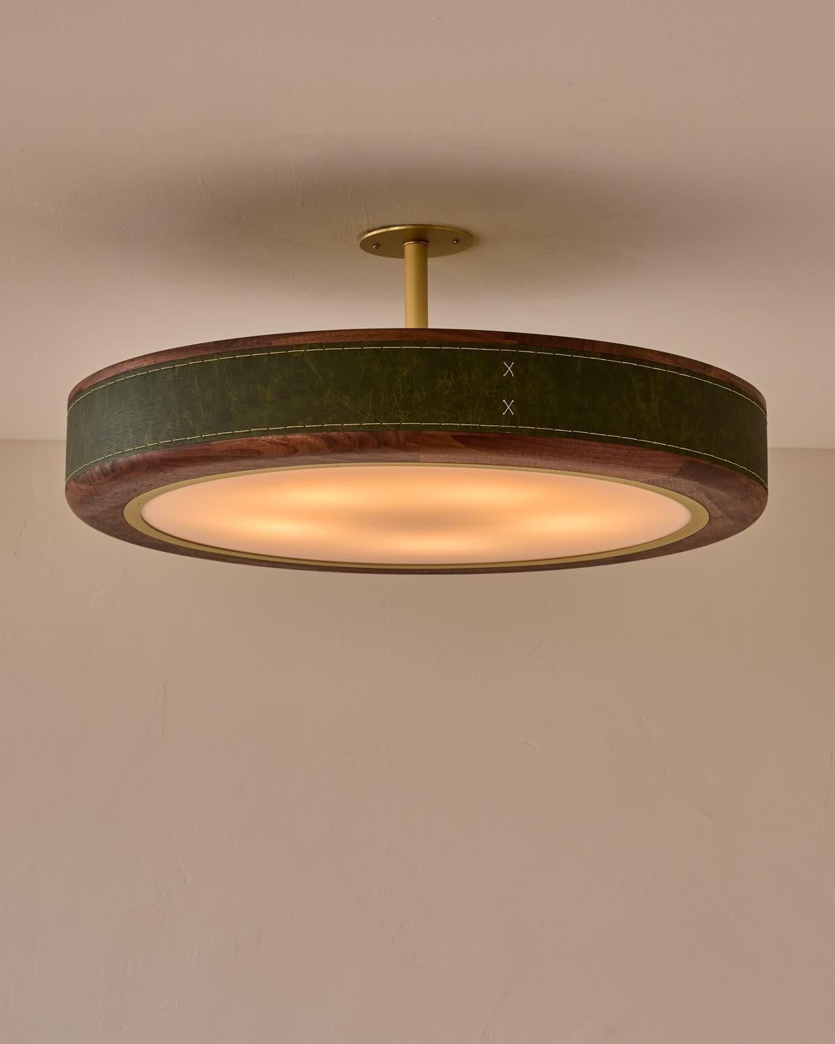 The Nura Ceiling Fixture combines hand-stitched leather over walnut accented by a brass pole and canopy. This fixture can either be hung as a ceiling surface mount or a pendant supported by a brass pole.

OVERALL DIMENSIONS
Shade: 30