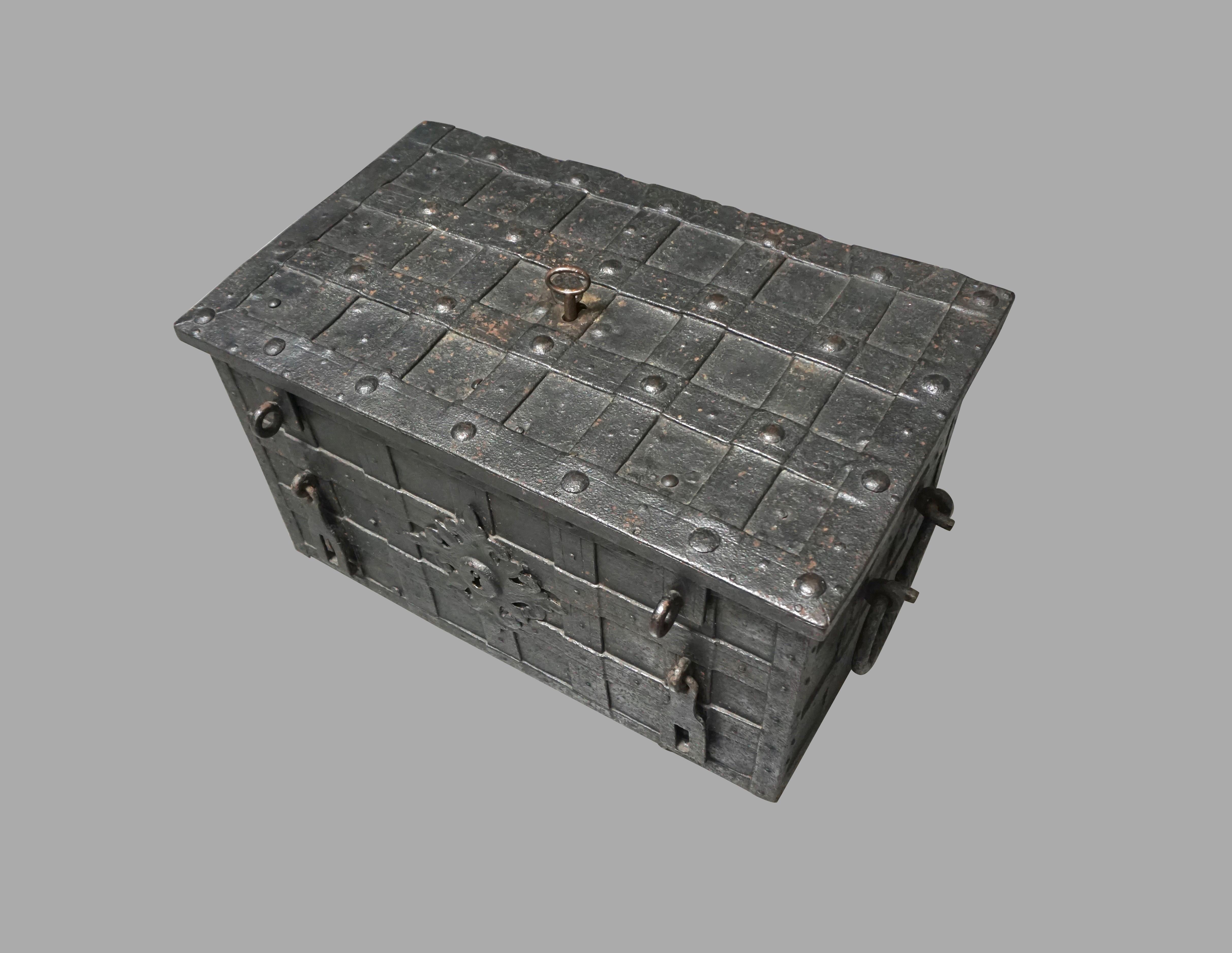 A good German (Nuremberg) late 17th century or early 18th century wrought iron armada chest of rectangular form, bound with riveted strapwork and bale handles to each side, retaining an elaborate and functional locking mechanism with an engraved