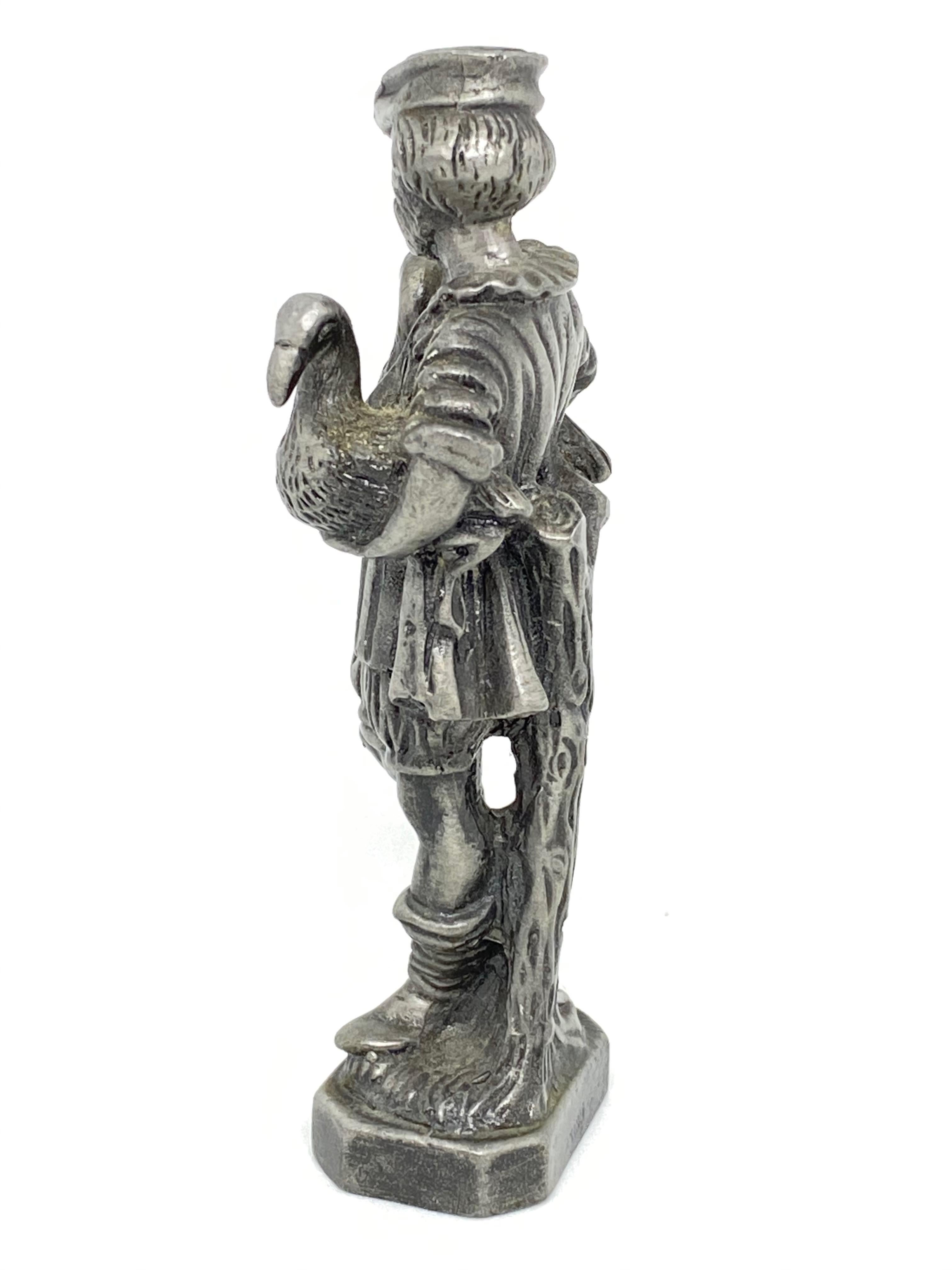A beautiful pewter figurine of the goose man, a statue in the middle of a water fountain in Nuremberg, Germany. Some wear with a nice patina, but this is old-age. Made of metal. A beautiful nice item to display in your collection. Last picture is
