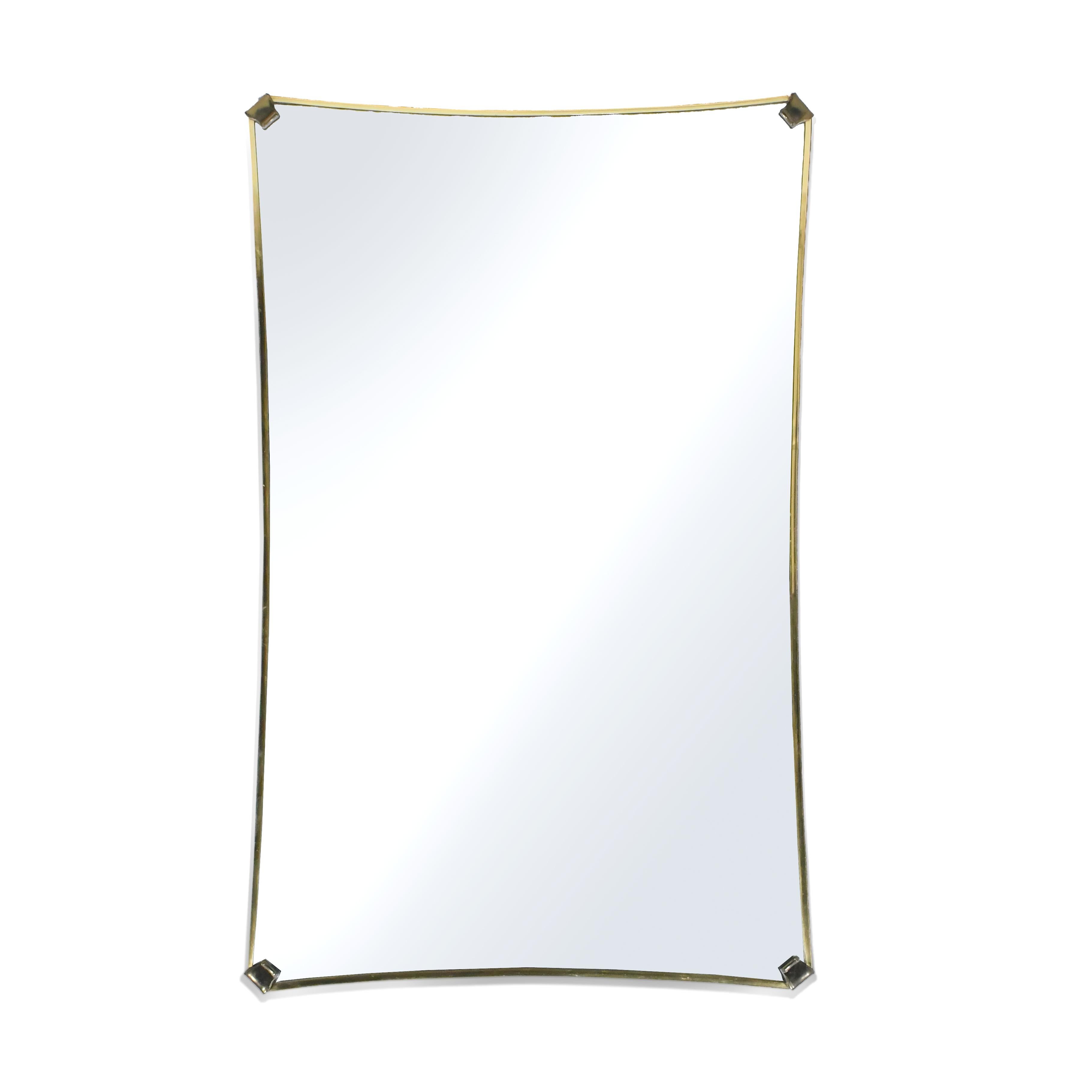 This stately sculpted wall mirror with a slender brass frame by Nurre is designed to be hung either horizontally or vertically.

The brass has a lovely patina from age and the subtle form works in a variety of spaces from traditional, to Hollywood