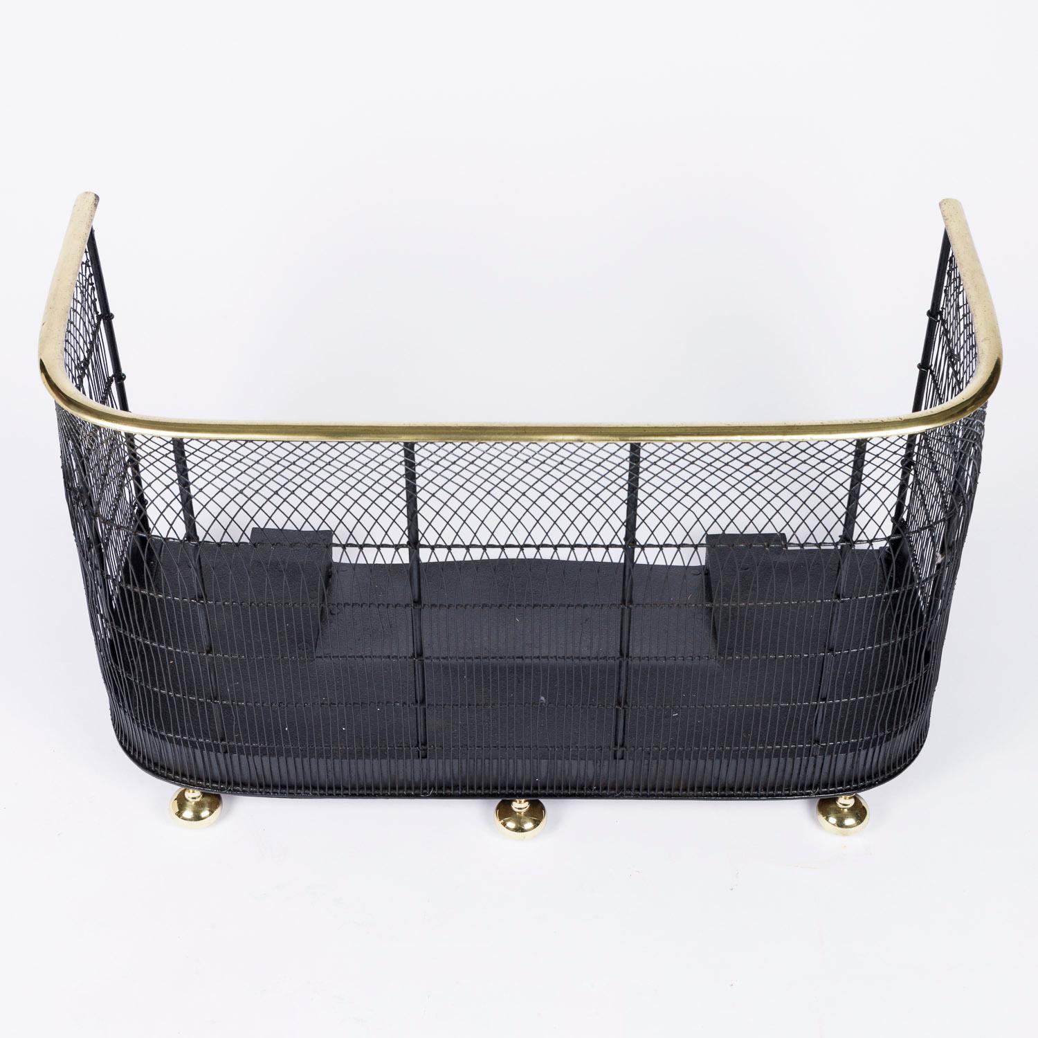 An Edwardian nursery fender, fireplace spark guard.

With brass rail and bun feet.

Curved woven black mesh in arch form.

