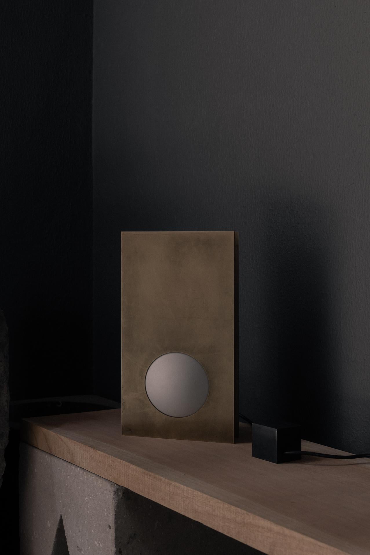 Nuum Table Lamp in Aged Brass with Opal Glass Sphere by Nuumbra
Dimensions: D 13 x W 21 x H 38 cm. 
Materials: Opal glass and aged brass.

Available in blackened steel or in aged brass. Prices may vary. All our lamps can be wired according to each