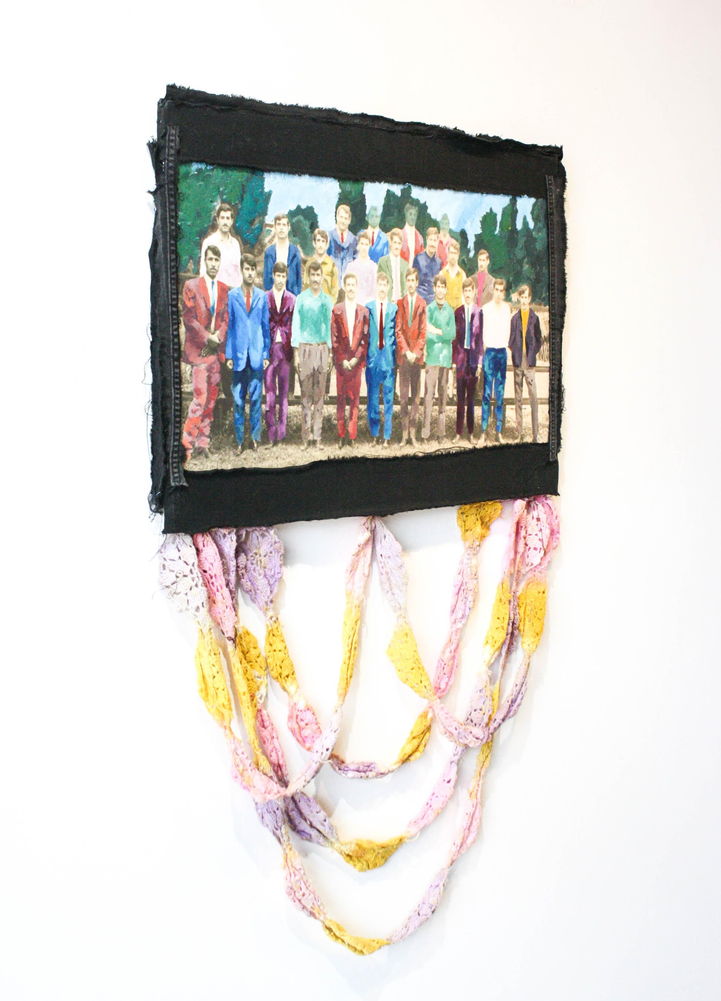 This mixed media piece has fabric draped down from an image of several people in rows. 

Artist Statement: 

I employ collage to reflect on the fragmented state of diasporic living in a stateless community. My making process involves gathering and