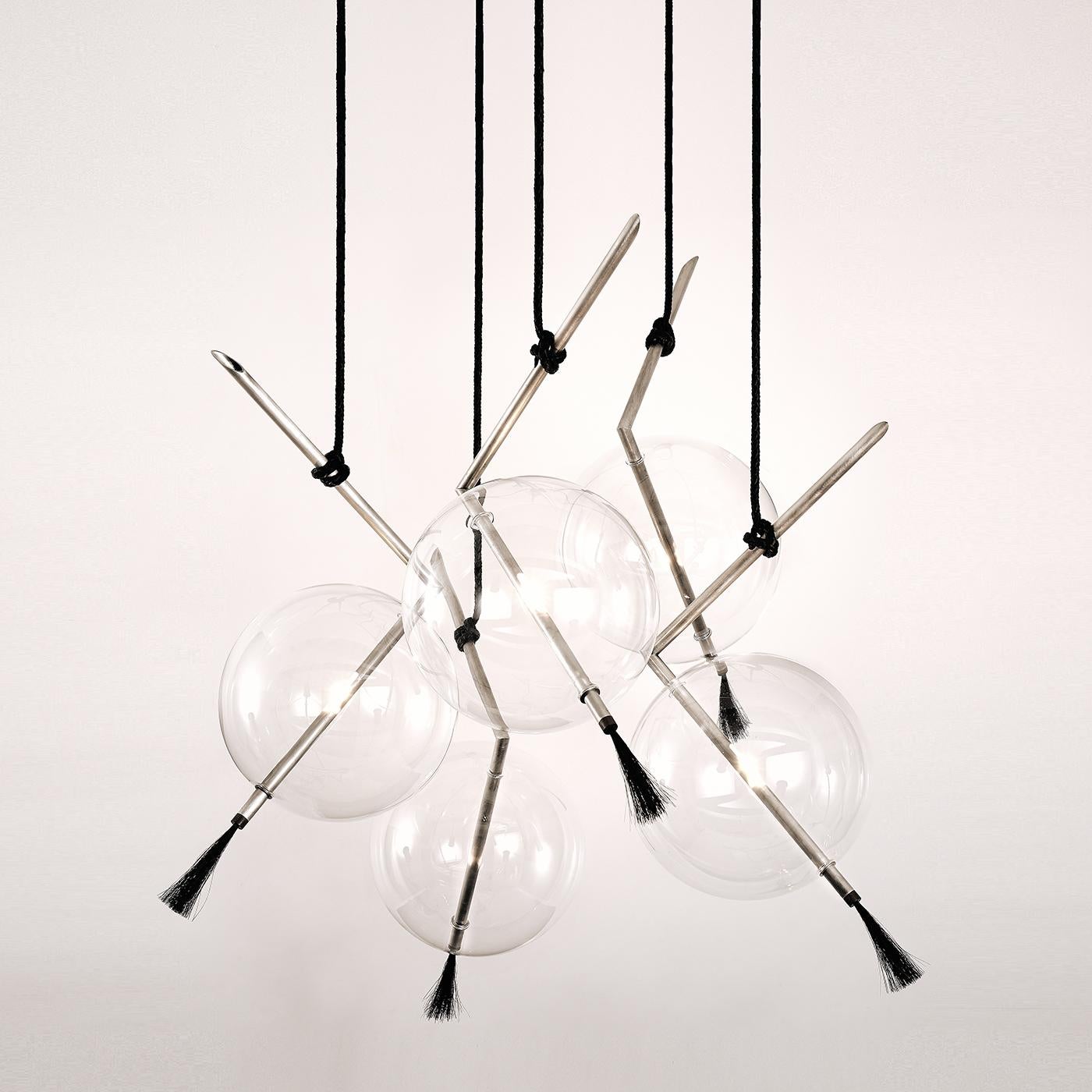 An eclectic mix of materials balanced in a contemporary design of great visual impact, this chandelier of the exclusive silver edition will create a dramatic focus in any interior. Five V-shaped arms made of brushed brass with a protective coating