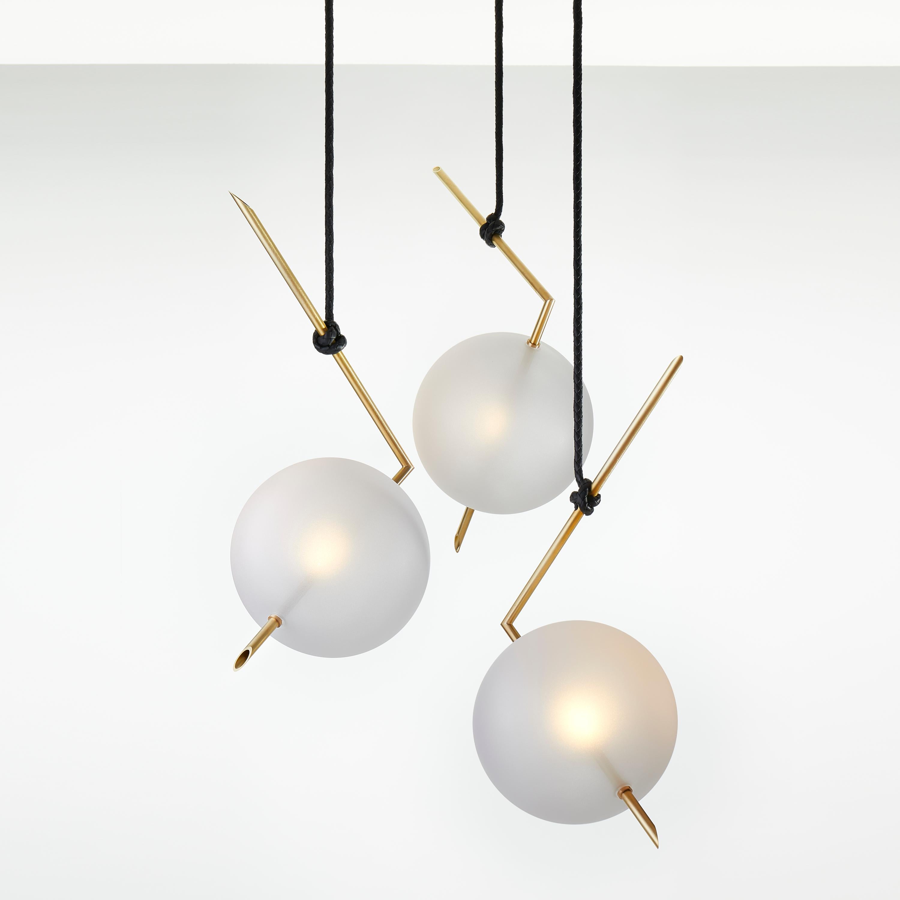 Nuvola Contemporary Pendant light floats in space like a jewel hanging from the ceiling, hooked at the end of a leather cord that has been hand-knotted around the brass tube; a perfect equilibrium of different materials, with obsessive attention to