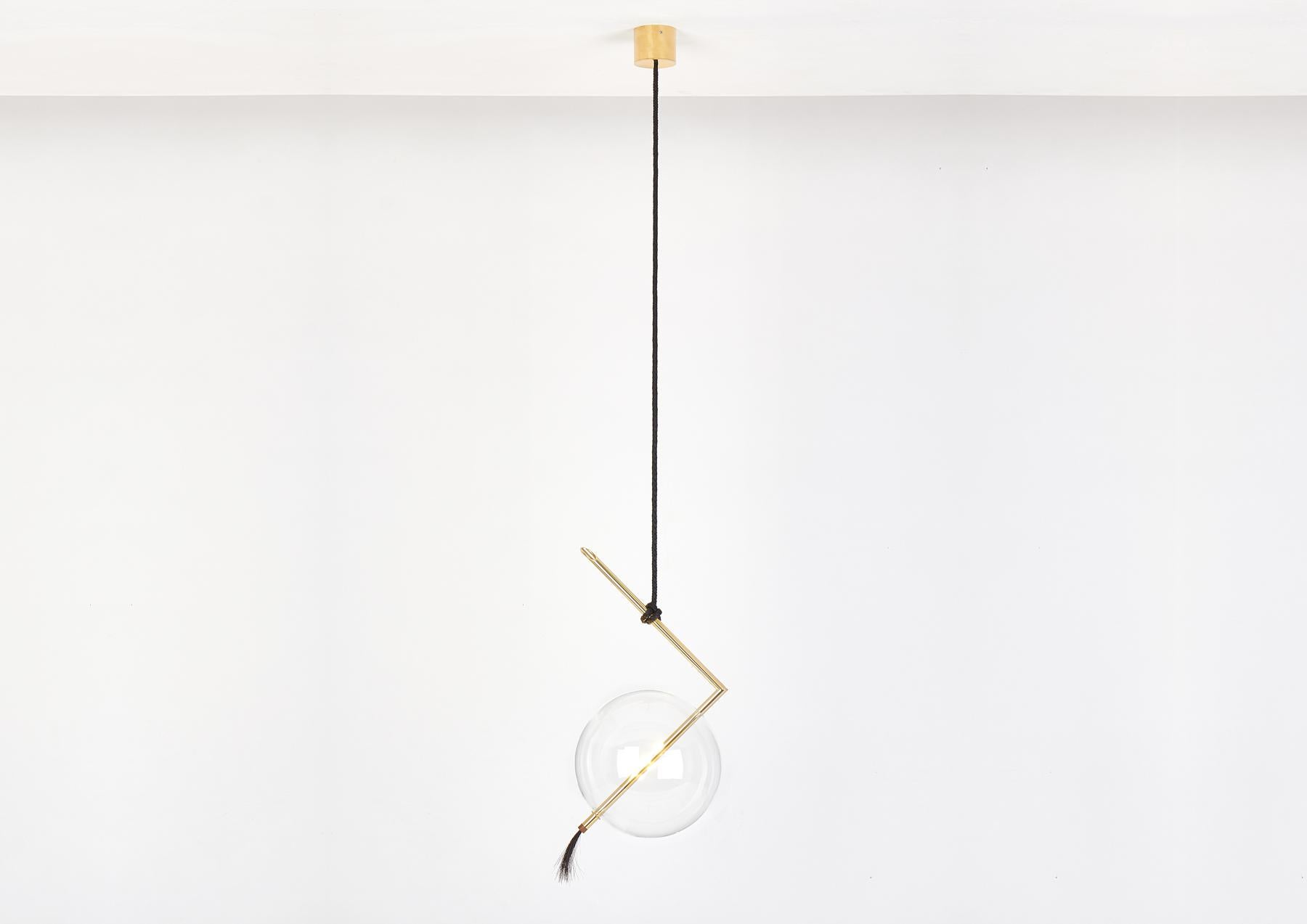 Nuvola pendant floats in space like a jewel hanging from the ceiling, hooked at the end of a leather cord that has been hand-knotted around the brass tube; a perfect equilibrium of contrasting materials, with obsessive attention to details.

The