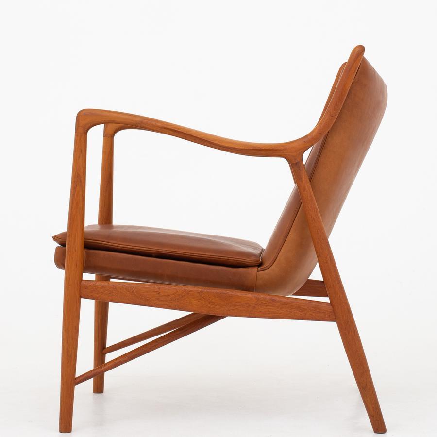 NV 45 - Easy chair in teak and patinated leather, stamped. Maker Niels Vodder.