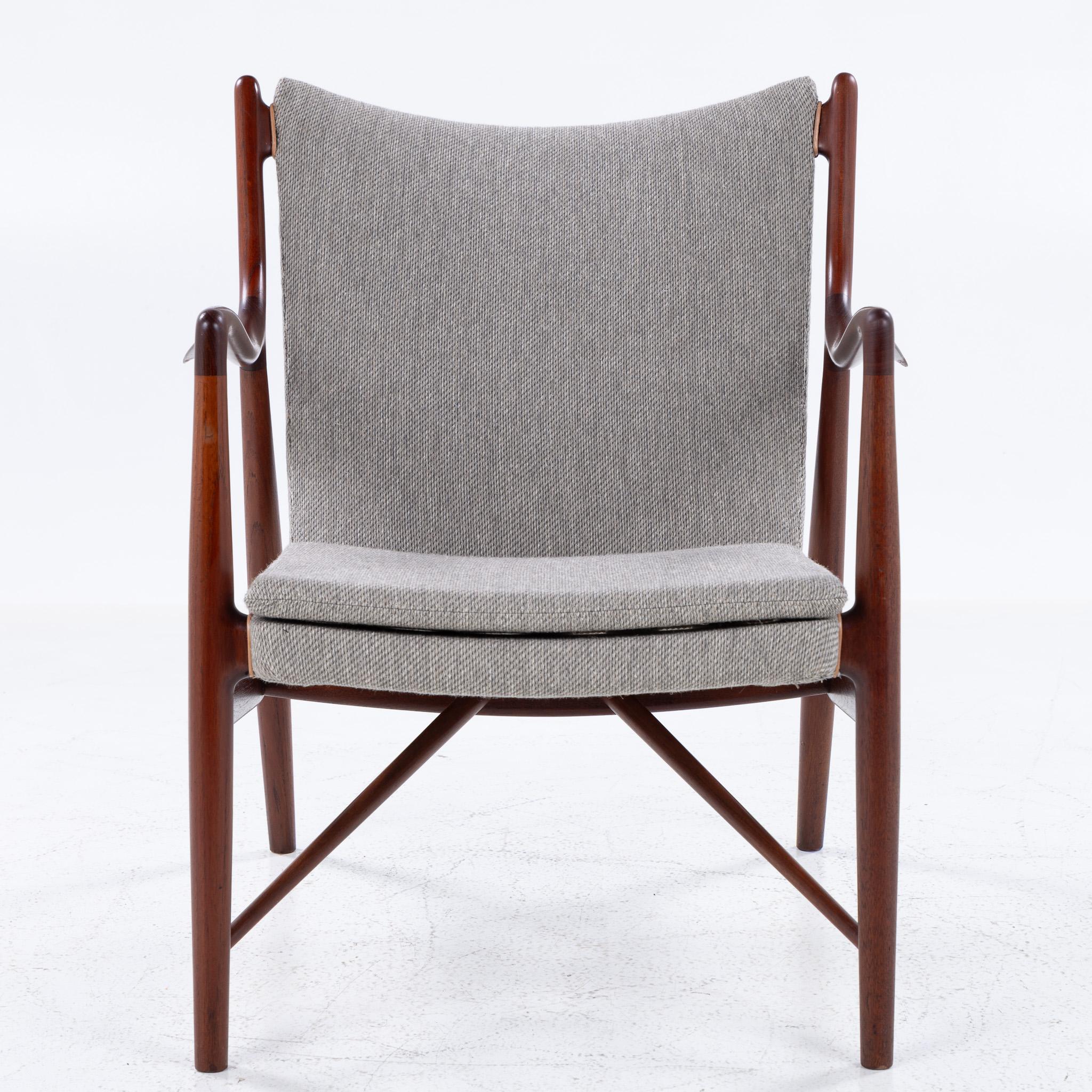 NV 45 - Rare easy chair in solid teak and new light grey textile from Kjellerup Væveri (COLOR 10-103). Labelled from manufacturer Niels Vodder.

Designed in 1945 and exhibited at the Cabinetmakers' Guild Furniture Exhibition the same year.