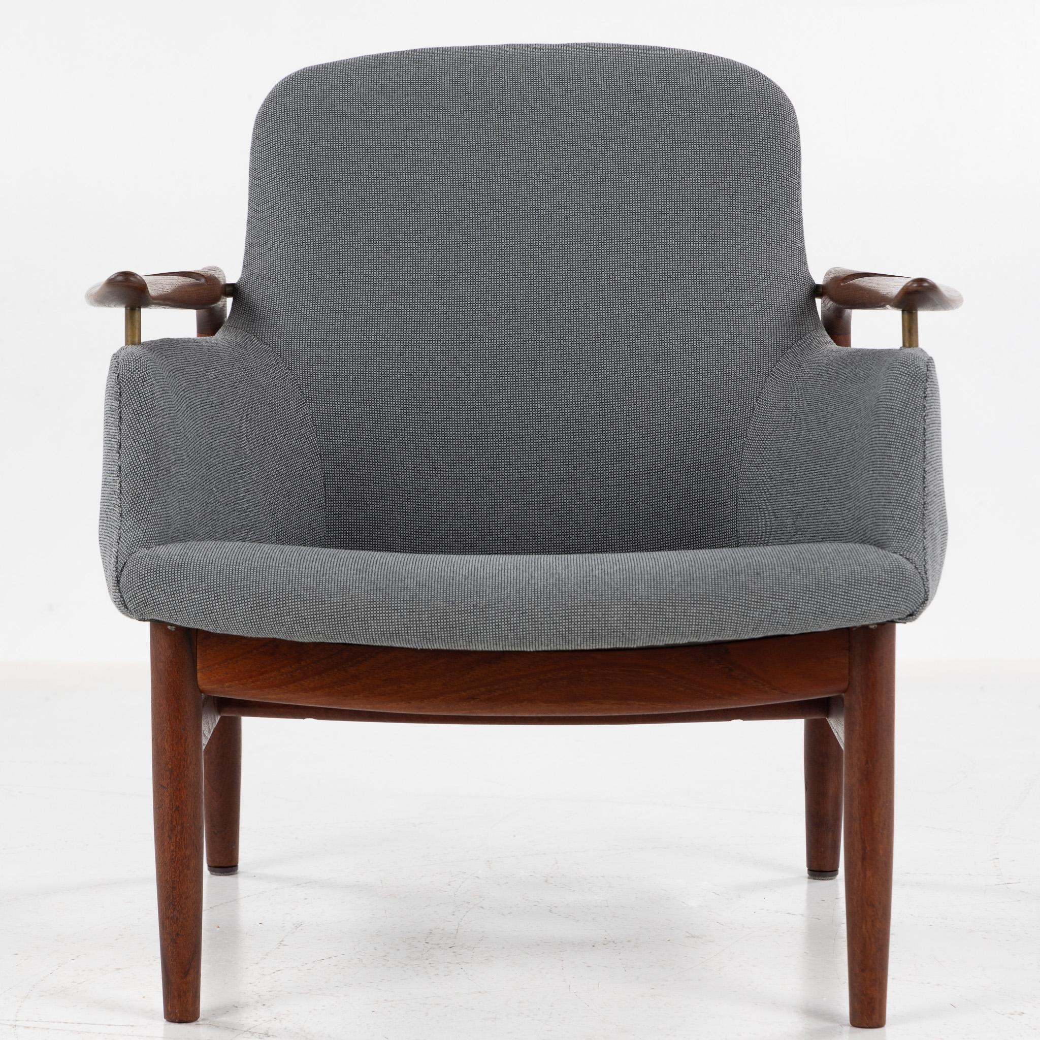 NV 53 - Rare armchair in solid teak with dark gray textile. Stamped by the carpenter. 
Designed in 1953 by Finn Juhl and made by cabinetmaker Niels Vodder.