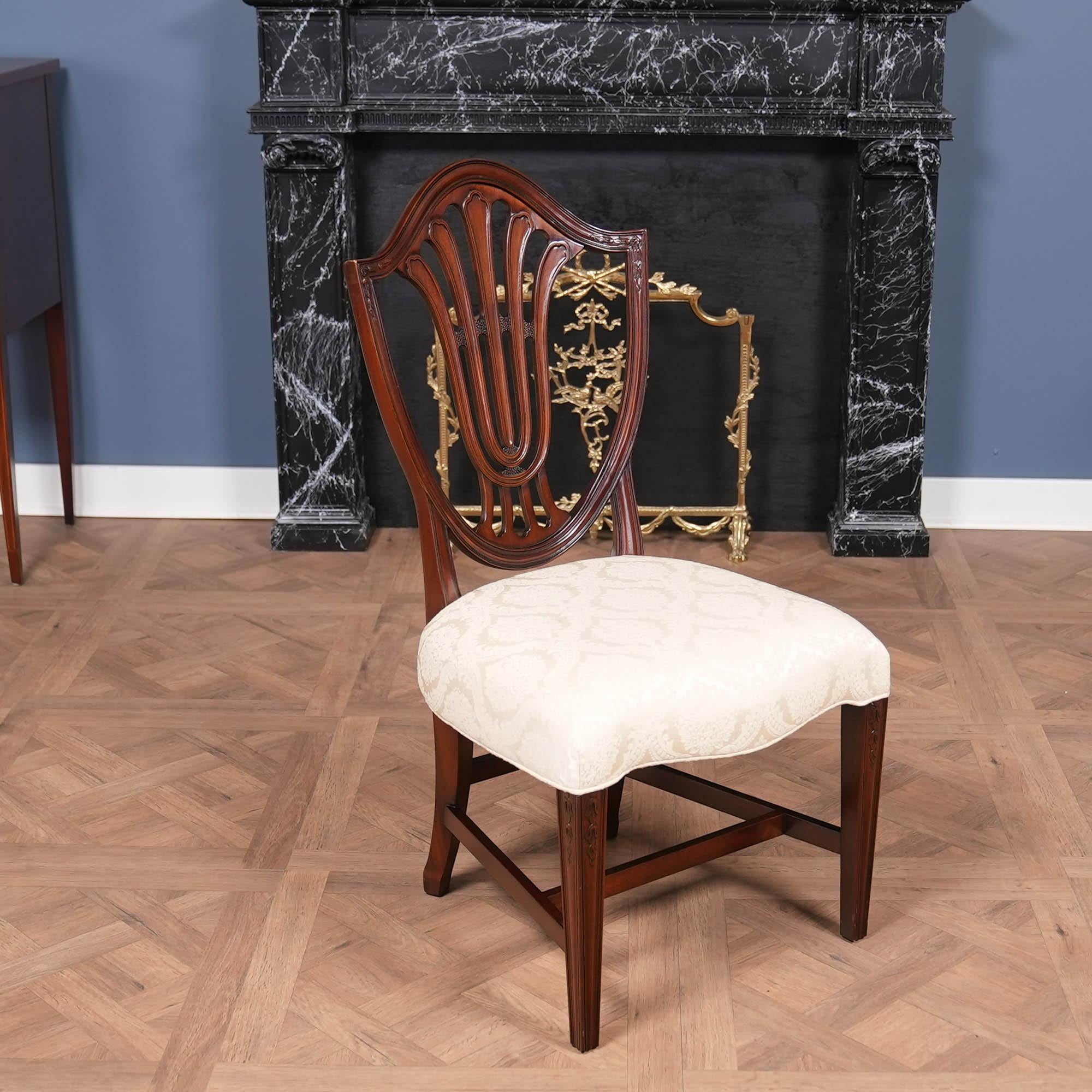 A Vintage Vintage Millinder Set of 4 Shieldback Chairs which will be the focal point of any space in which they are placed. Hand crafted from solid mahogany this beautiful set of Vintage Millinder Set of 4 Shieldback Chairs are in original condition