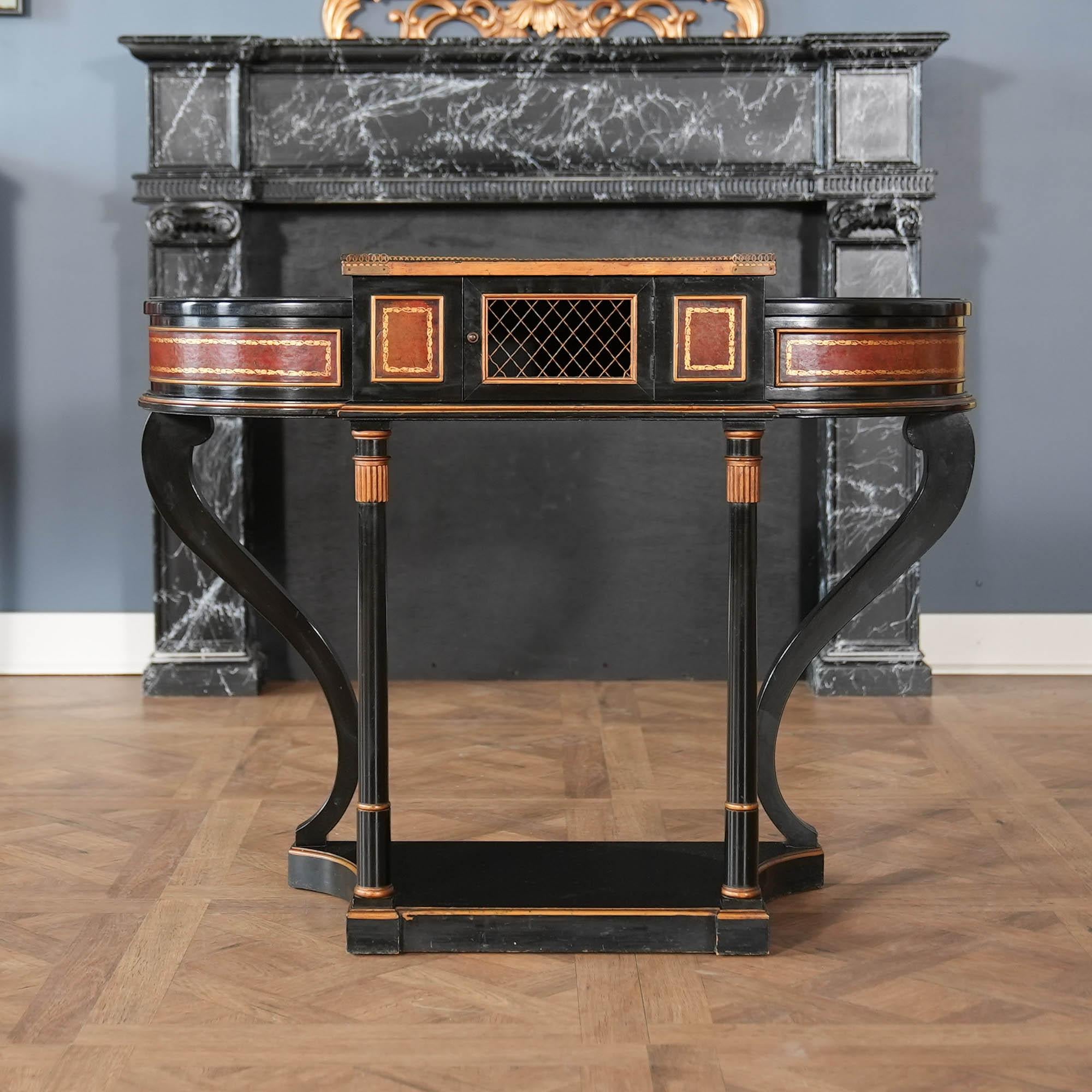 A beautiful and decorative Console and Planter Combination with ebonized and gold accents throughout. The console also features beautiful leather work and a brass gallery both of which are in remarkable condition given the age of this piece. Most