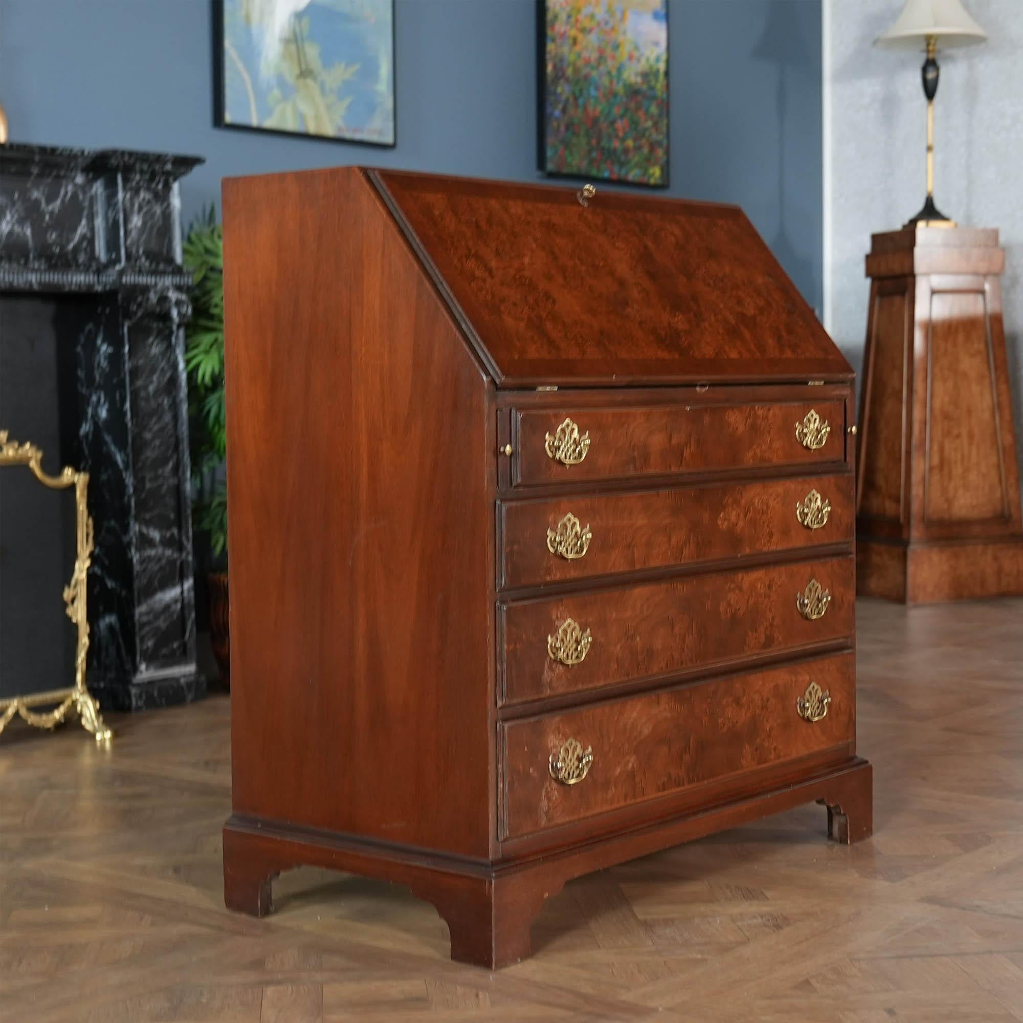 
A Vintage Hickory Furniture Secretary Desk brought to you by Niagara Furniture. This desk is impressive in both it’s design and scale. Made of beautifully grained walnut, the secretary bookcase features double domed arches on the top as well as