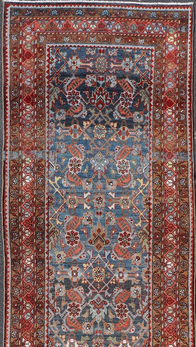 Hand-Knotted N.W. Persian Antique Runner with Geometric Florals Set on a Blue Field For Sale