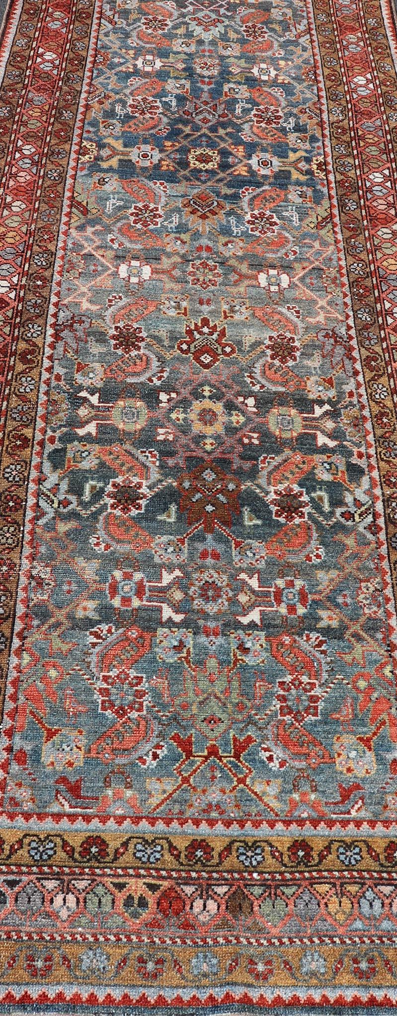 Wool N.W. Persian Antique Runner with Geometric Florals Set on a Blue Field For Sale