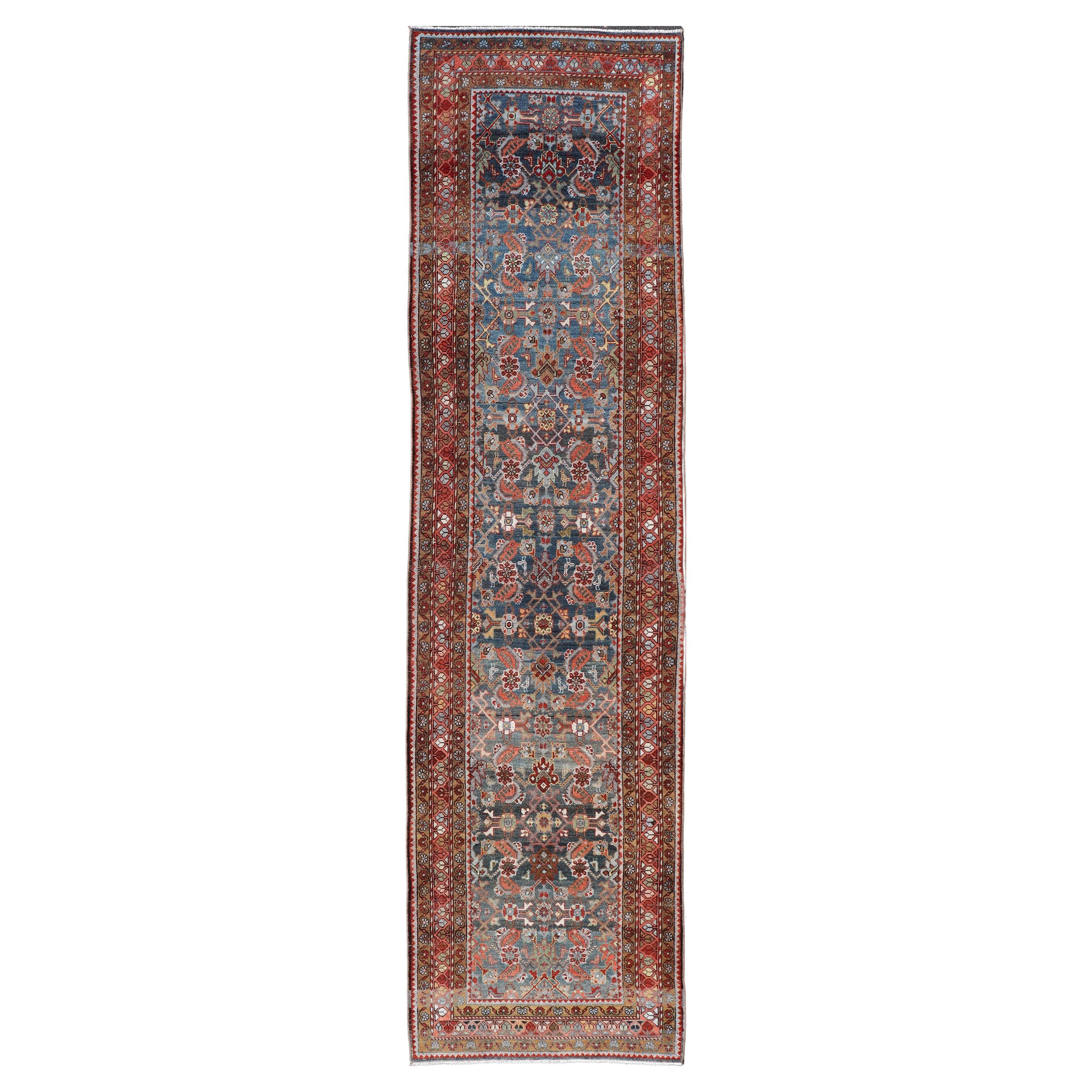N.W. Persian Antique Runner with Geometric Florals Set on a Blue Field For Sale