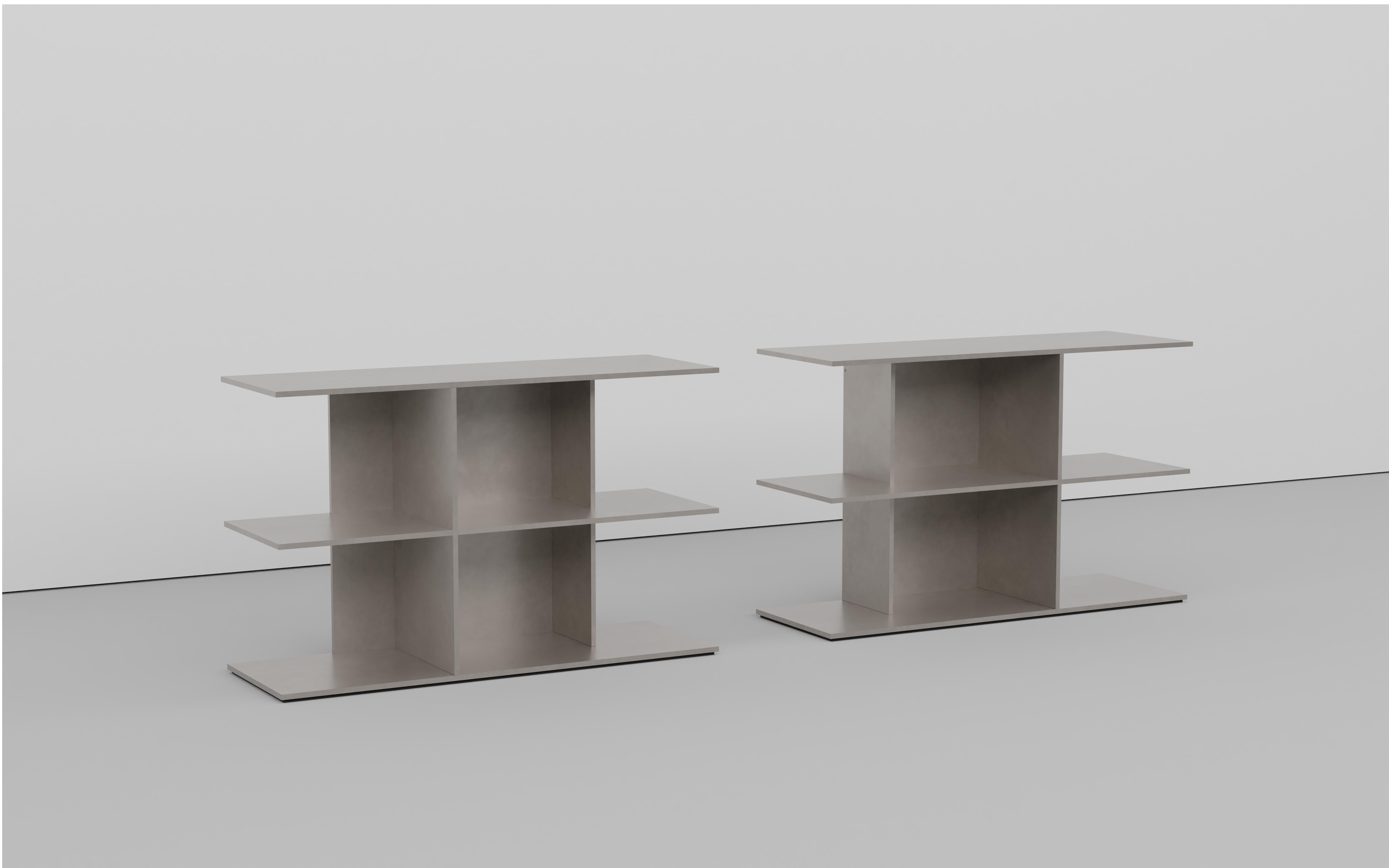Minimalist tiered table in bolted together 3-8 inch thick aluminum plate. The underside has a recessed, cut rubber sheet with an inset signed label. Available in mirrored left and right models. Made to be a book shelf and with a cushion, a window