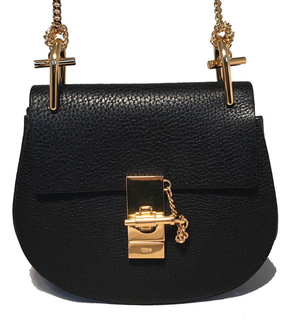 NWOT Chloe Mini Drew Black Leather Saddle Bag in like new condition. Black grained leather trimmed with gold hardware. Unique gold chain shoulder strap tied at either end. Front turn lock flap closure opens to an unlined interior with one side slit