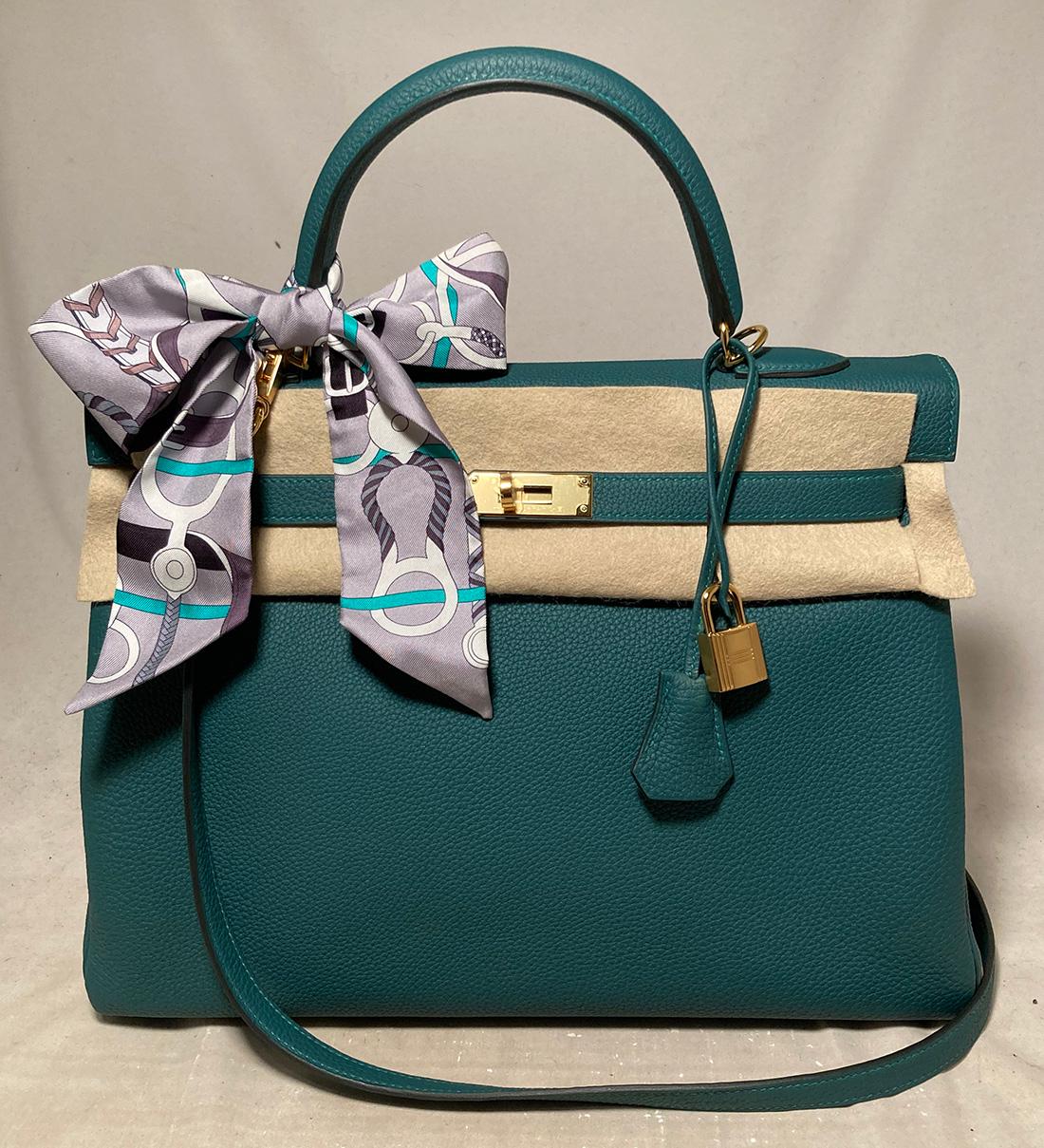 NWOT Hermes Malachite Green Togo Kelly 35 GHW in New Unused condition. Gorgeous rare malachite green togo leather trimmed with gold hardware. Clochette with keys and lock, shoulder strap, box, dust cover, raincoat and care booklet and twilly