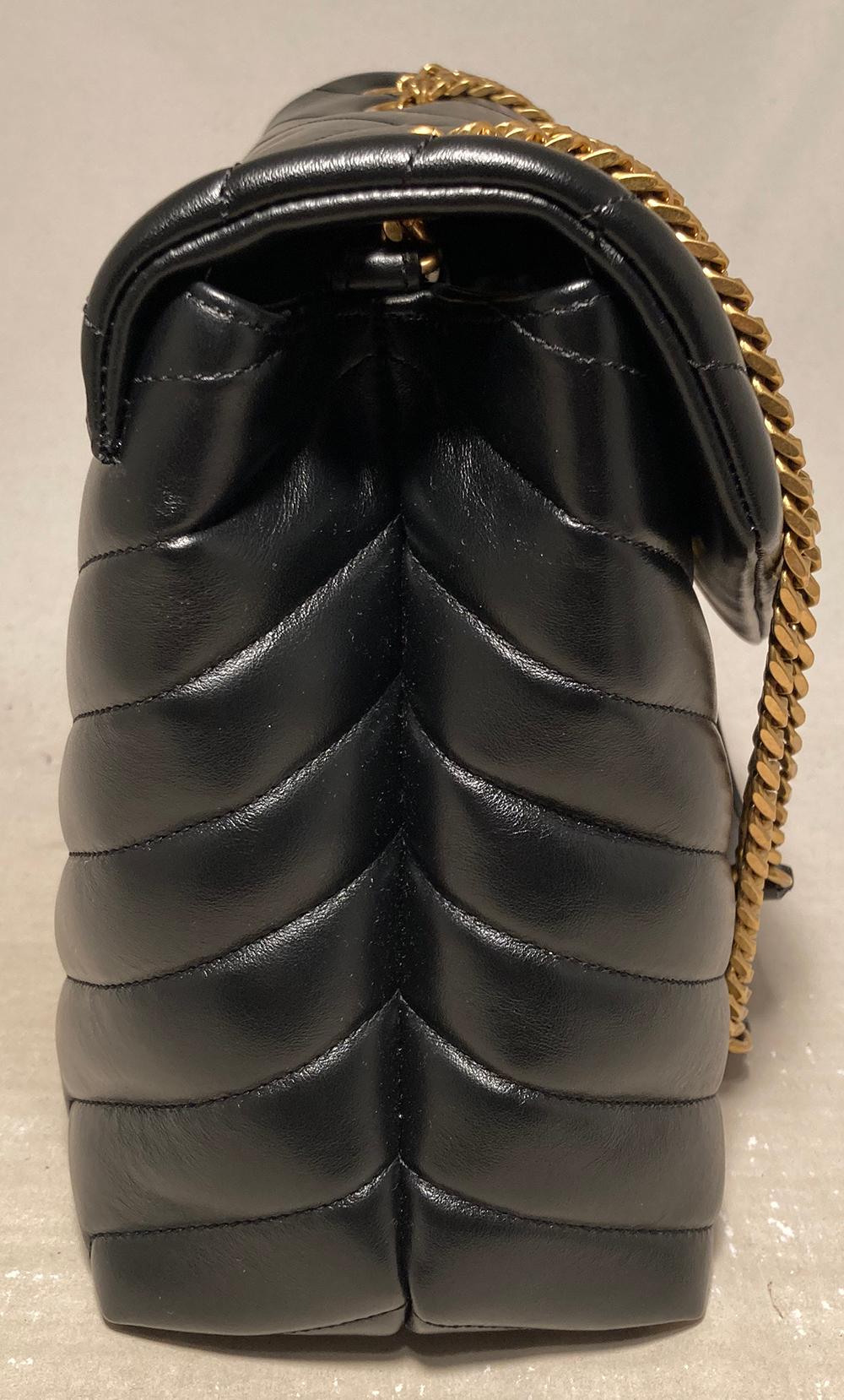 Saint Laurent Loulou Quilted Leather YSL Bag in New without tags condition. Black chevron quilted calfskin leather exterior trimmed with antiqued brass hardware. Front snap flap closure opens to a black satin lined interior with 2 storage
