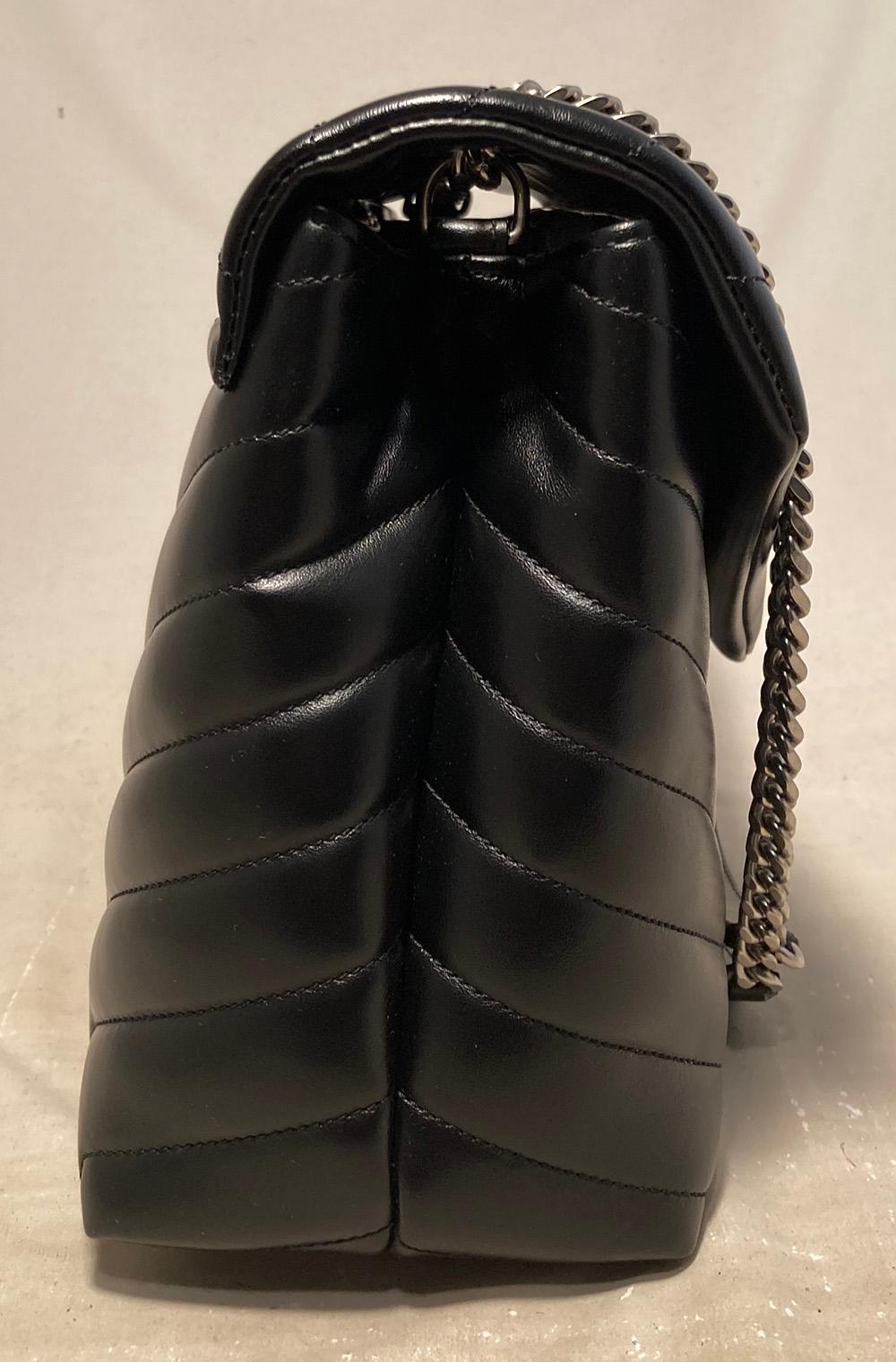 Saint Laurent Loulou Quilted Leather YSL Bag in New without tags condition. Black chevron quilted calfskin leather exterior trimmed with sparkling silver hardware. Front snap flap closure opens to a black satin lined interior with 2 storage