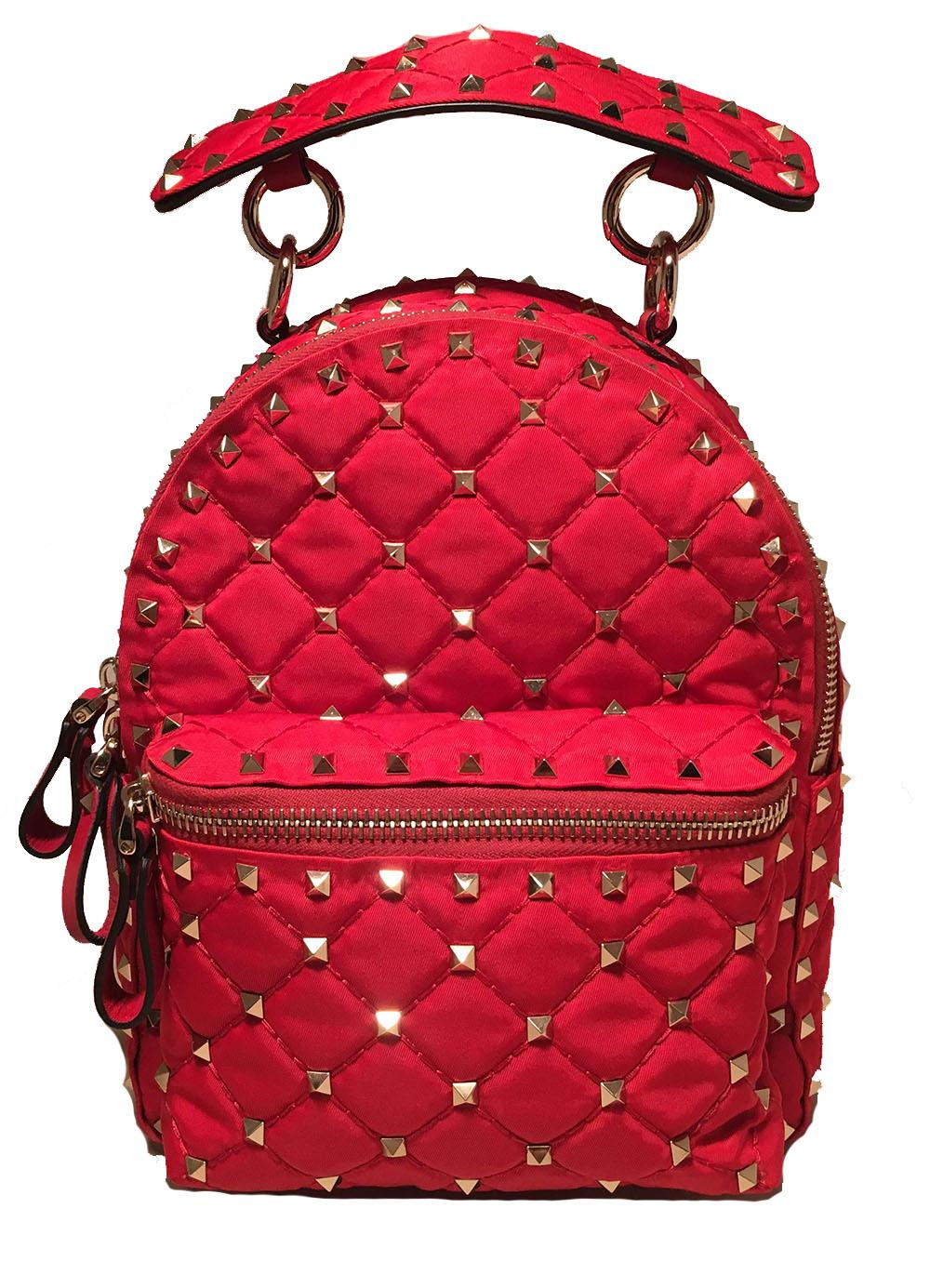 NWOT Valentino Red Nylon Mini Rockstud Backpack in excellent like-new condition. Red quilted nylon exterior trimmed with silver hardware and studs throughout and red leather.  Front zip exterior pocket. Full zip closure opens to red nylon interior