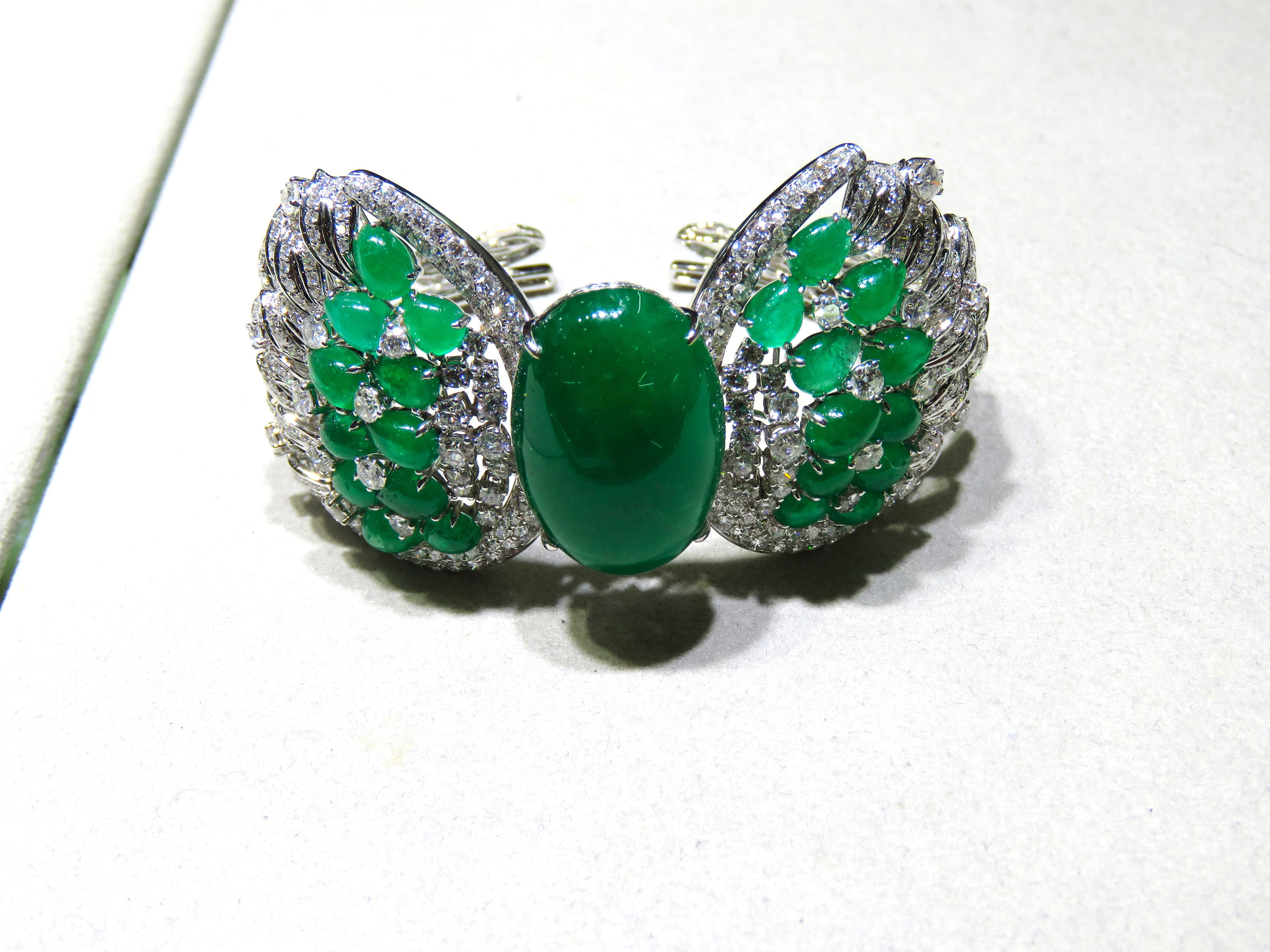 The Following Item we are offering is a Rare Important Radiant 18KT Gold Large Fancy Large Emerald and Diamond Bangle Bracelet Cuff.  Bracelet is comprised of Gorgeous Fancy Large Emeralds surrounded with Beautiful Glittering Fancy Diamonds. T.C.W
