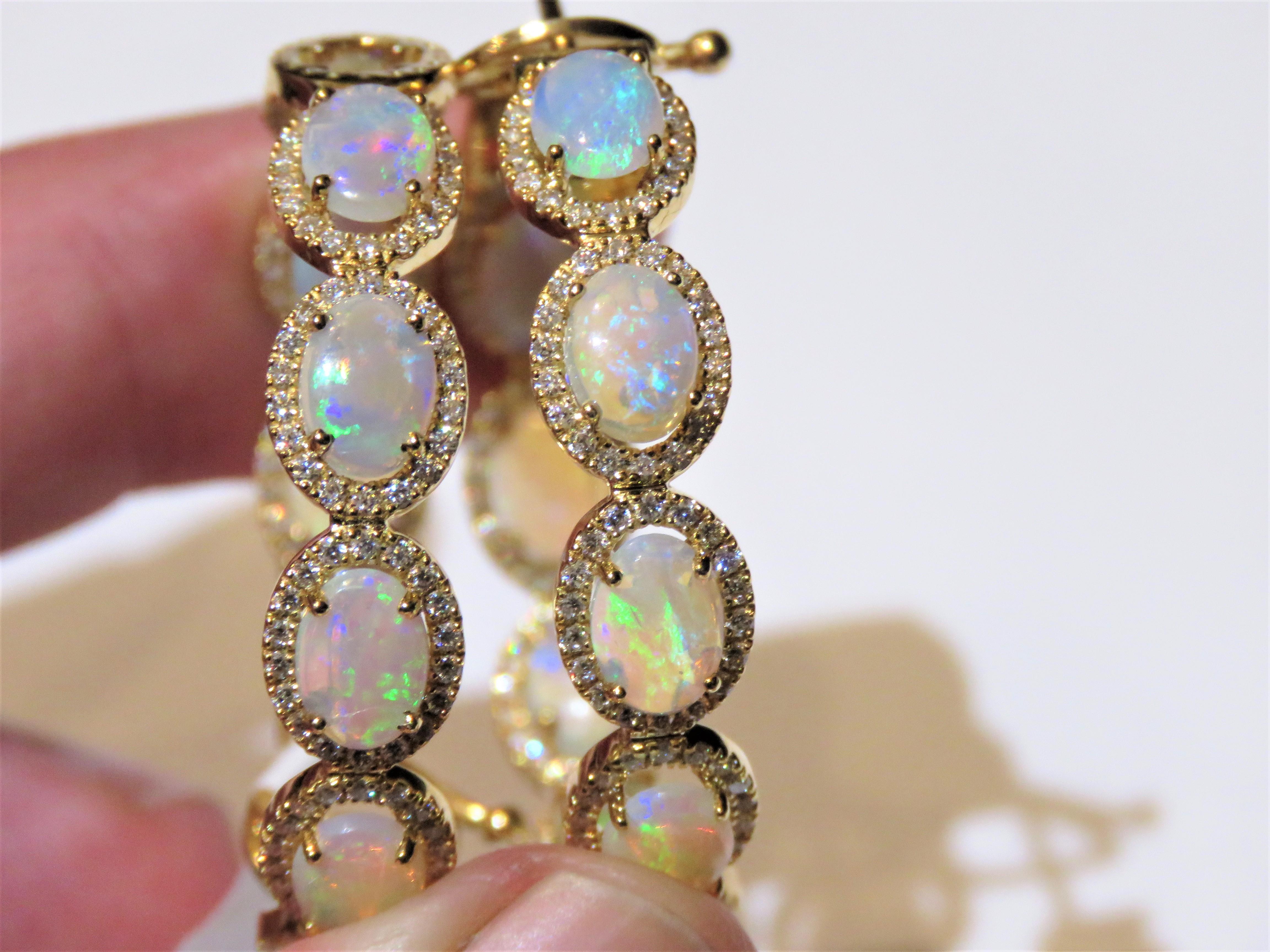 The Following Items we are offering is a Rare Important Spectacular and Brilliant 18KT Gold Large Gorgeous Fancy Opal and Diamond Dangle Hoop Earrings. Earrings consists of Rare Fine Magnificent White Ethiopian Opals surrounded and Framed with